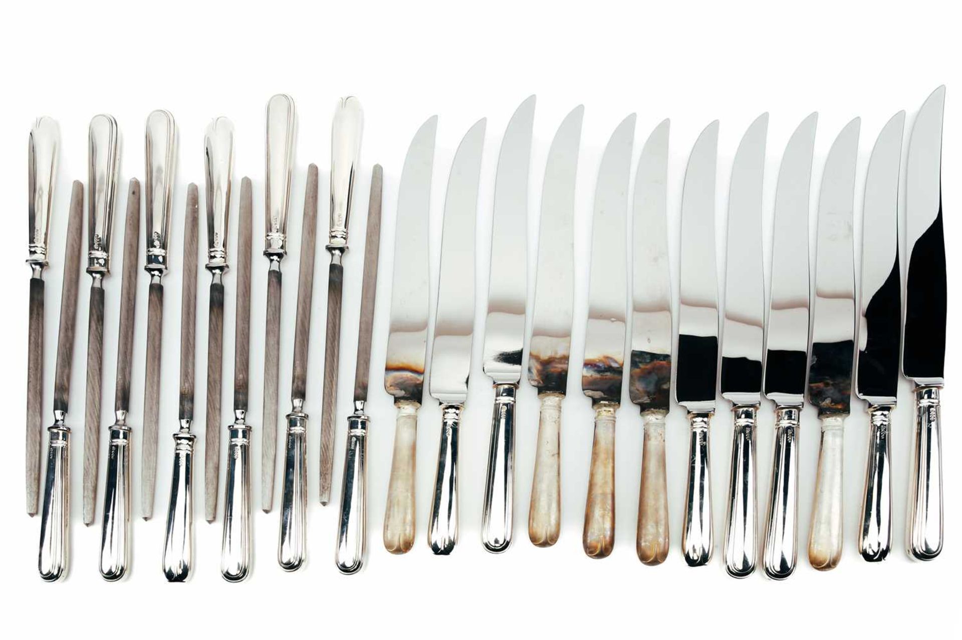 A mixed collection of modern silver-handled carving knives and silver-handled sharpening steels