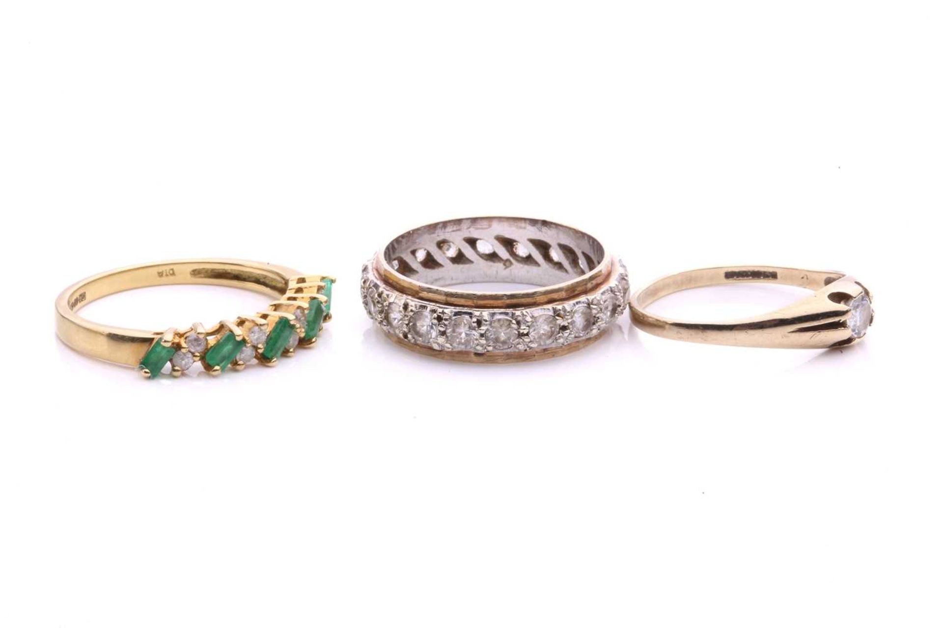 Three gem-set rings in gold; to include an 18ct gold ring set with alternating emeralds and - Image 2 of 4