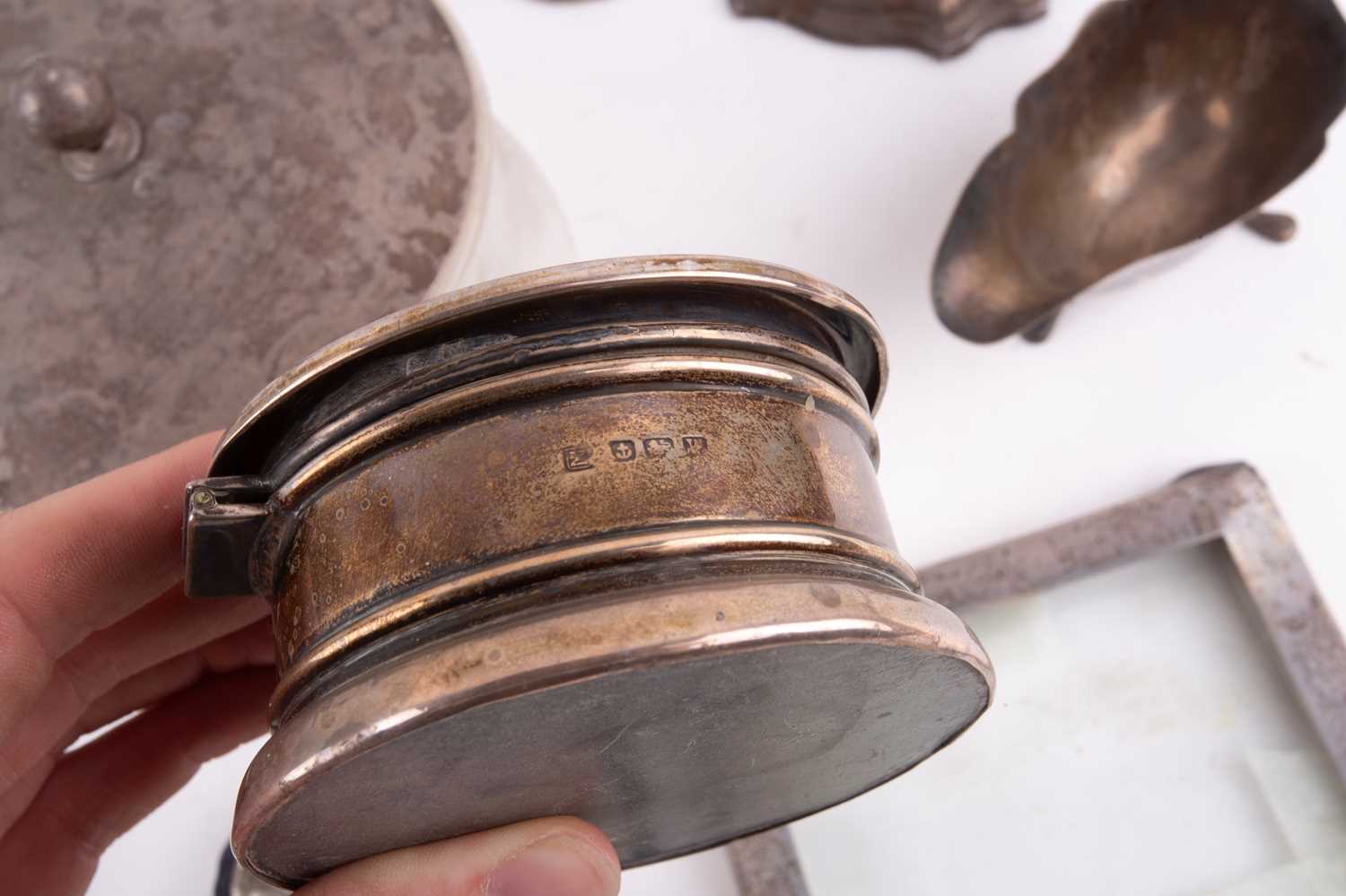 A small collection of silver, comprising a pair of candlesticks with weighted bases, 18.5cm, a - Image 15 of 34