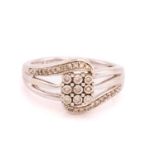 A diamond set panel-style ring, featuring a diamond set panel of nine diamonds with claw set 8-