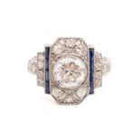 An Art Deco diamond sapphire panel ring, scintillating with an old-European cut diamond of 7.0 x 7.0