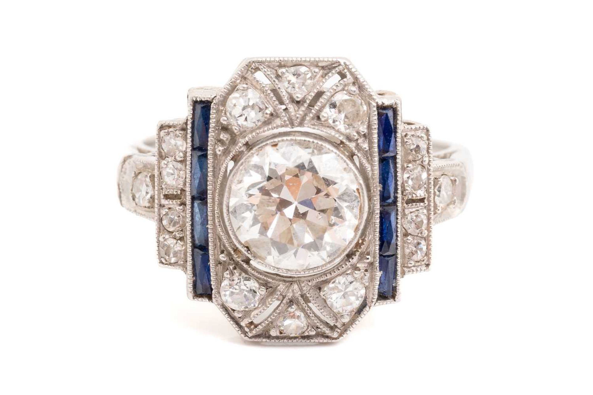 An Art Deco diamond sapphire panel ring, scintillating with an old-European cut diamond of 7.0 x 7.0