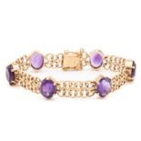 A bracelet set with amethysts in 9ct gold, comprising a wide bismarck link with six oval-cut