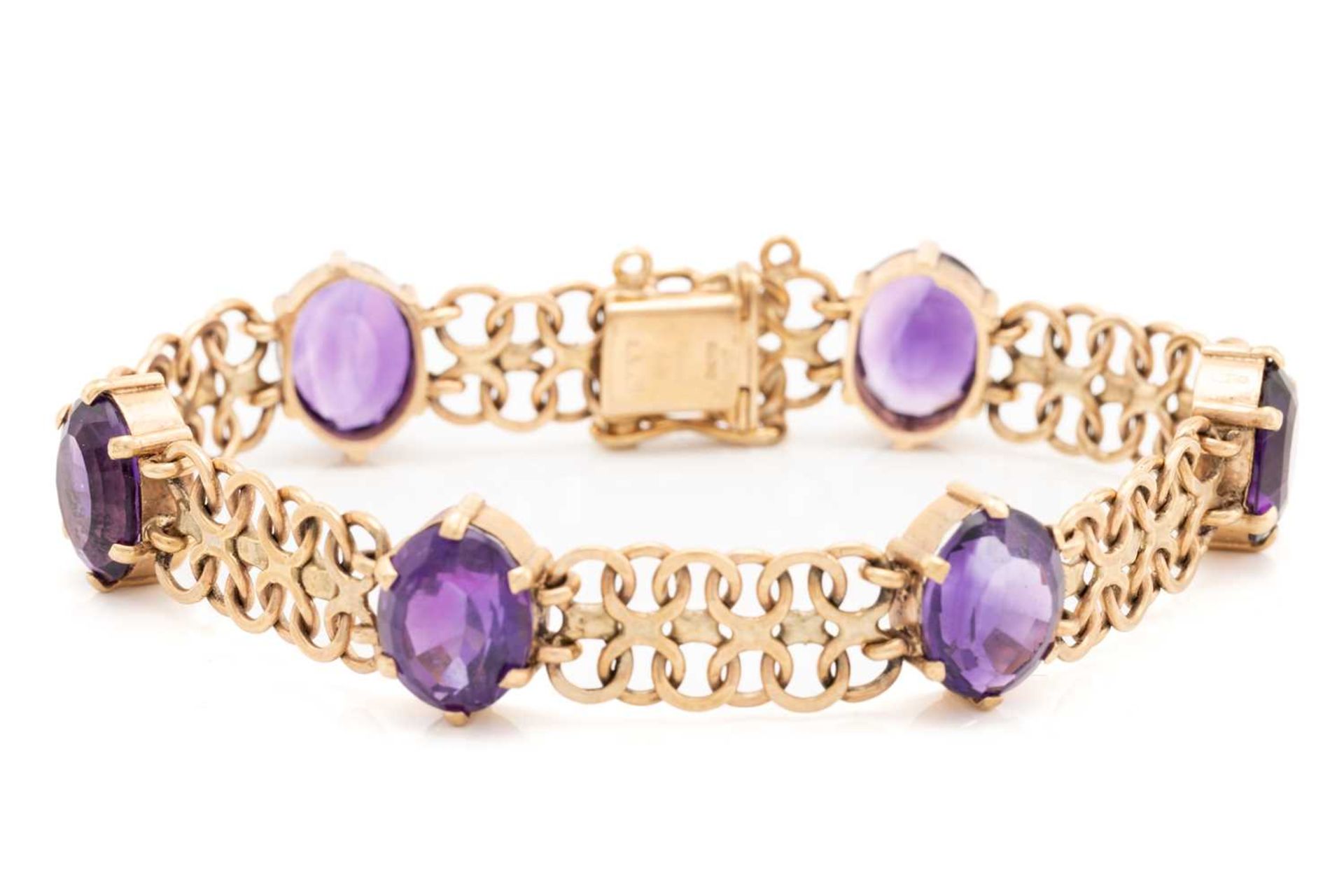 A bracelet set with amethysts in 9ct gold, comprising a wide bismarck link with six oval-cut