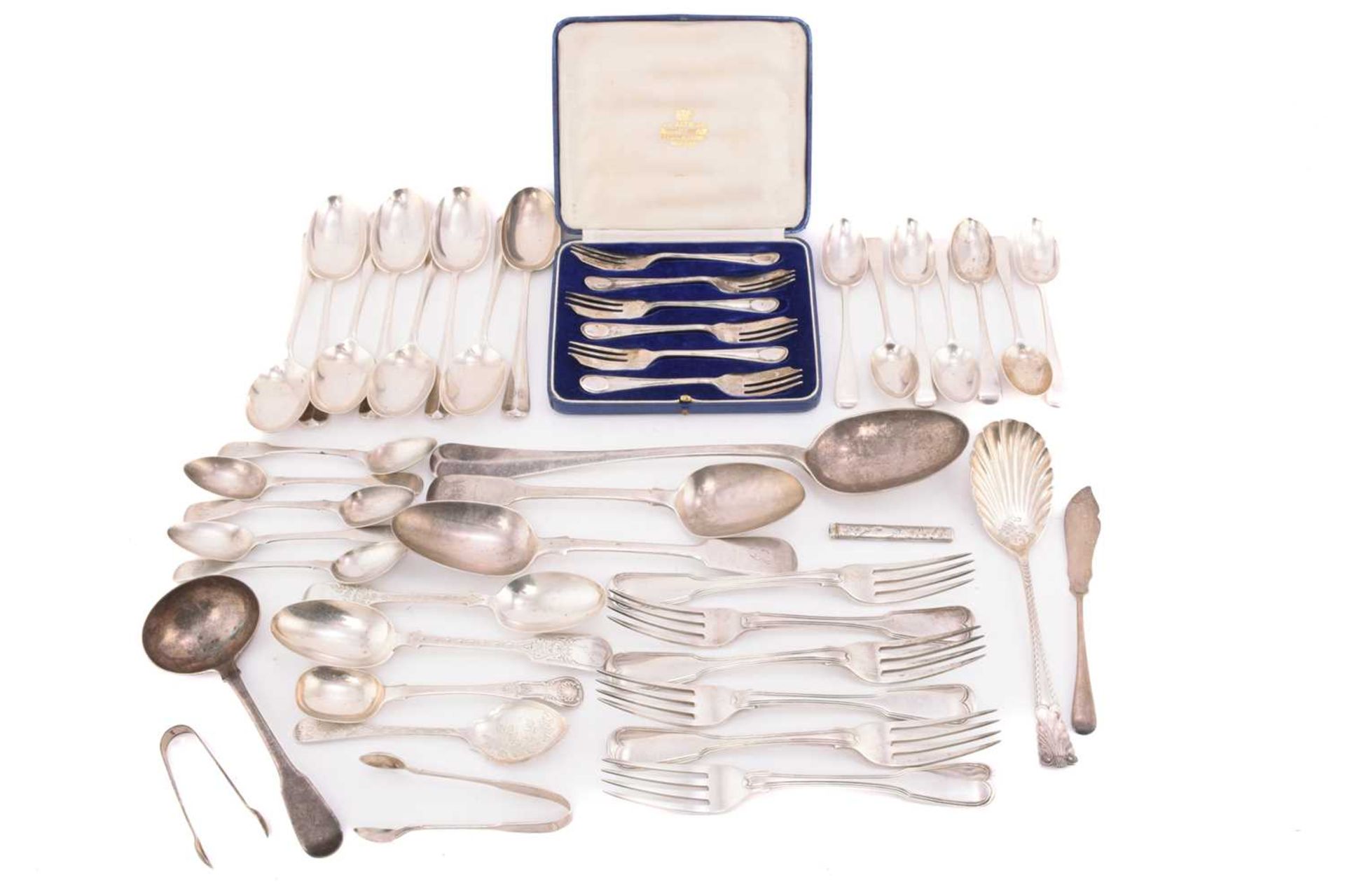 A collection of mixed assayed silver flatware, comprising a large basting spoon, two serving spoons,