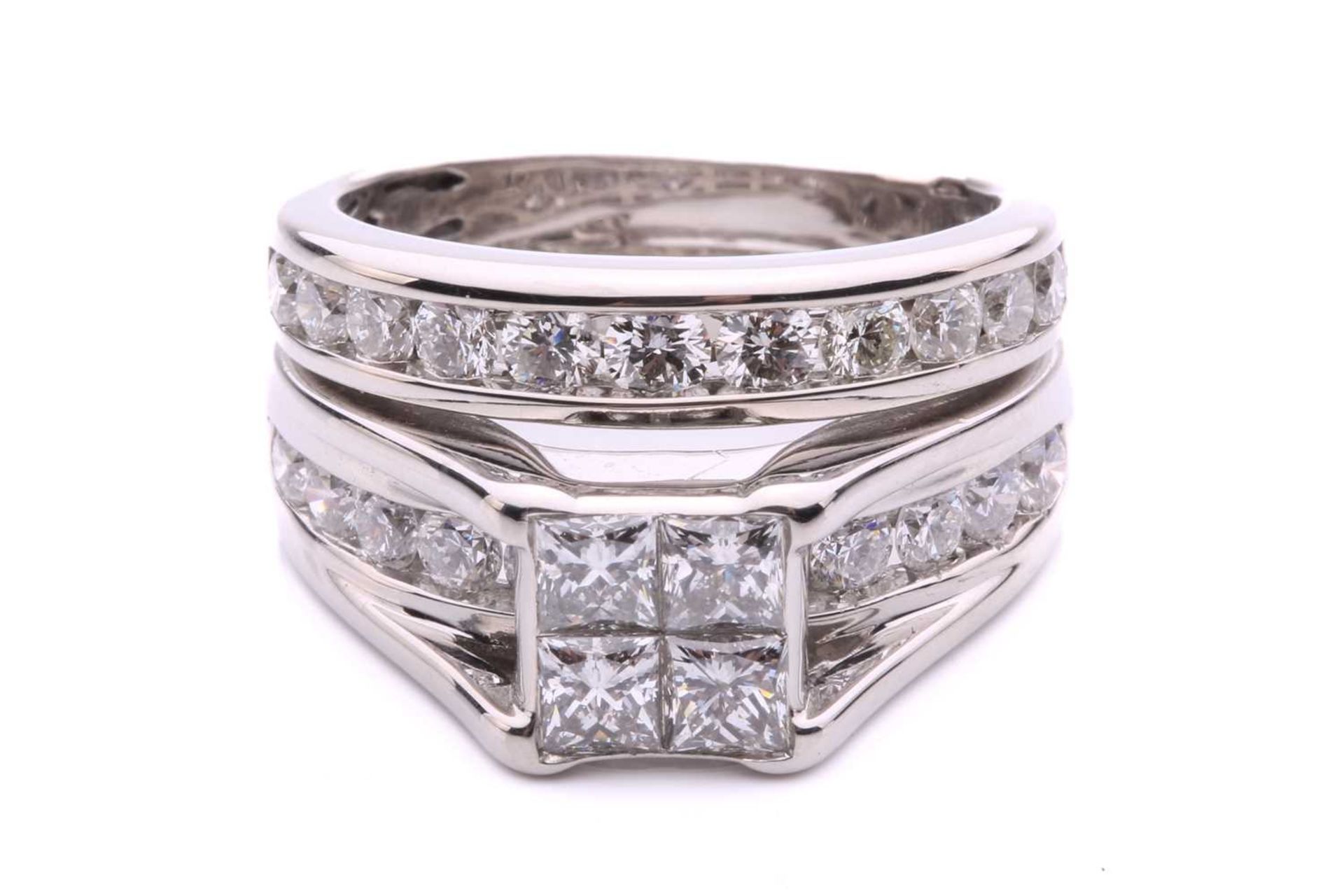 A diamond set bridal set rings, with 4 illusion set princess cut diamonds with an under hoop channel