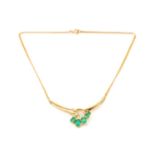 A necklace set with emeralds and diamonds, the crescent-shaped pendant emanating with five oval-