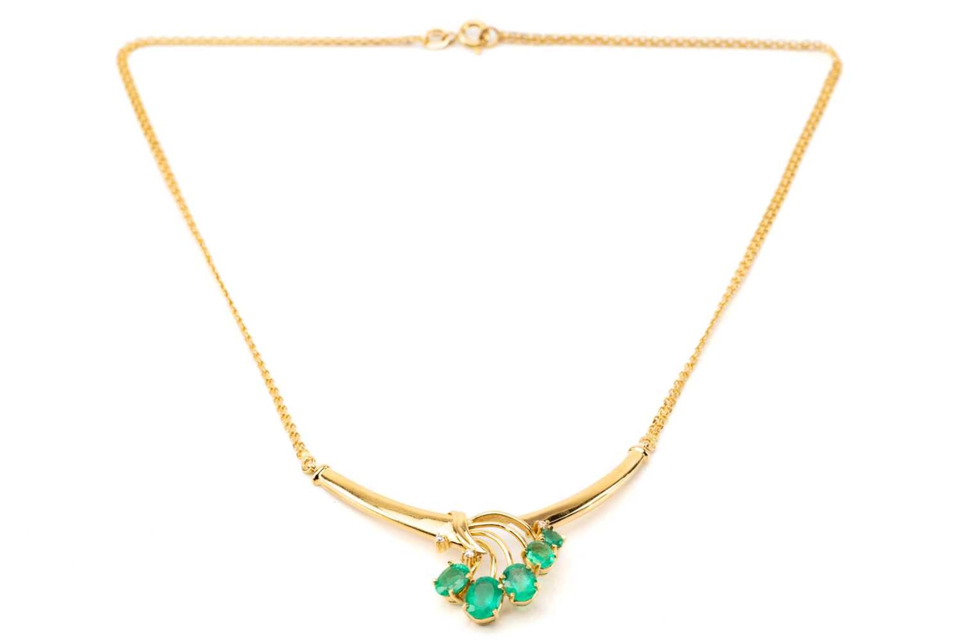 A necklace set with emeralds and diamonds, the crescent-shaped pendant emanating with five oval-