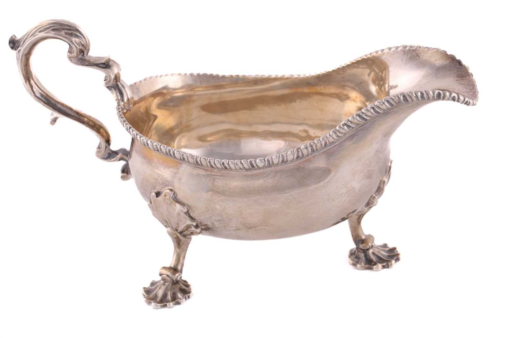 A pair of George II silver sauce boats; with gadrooned borders and leaf capped double scroll - Image 10 of 12