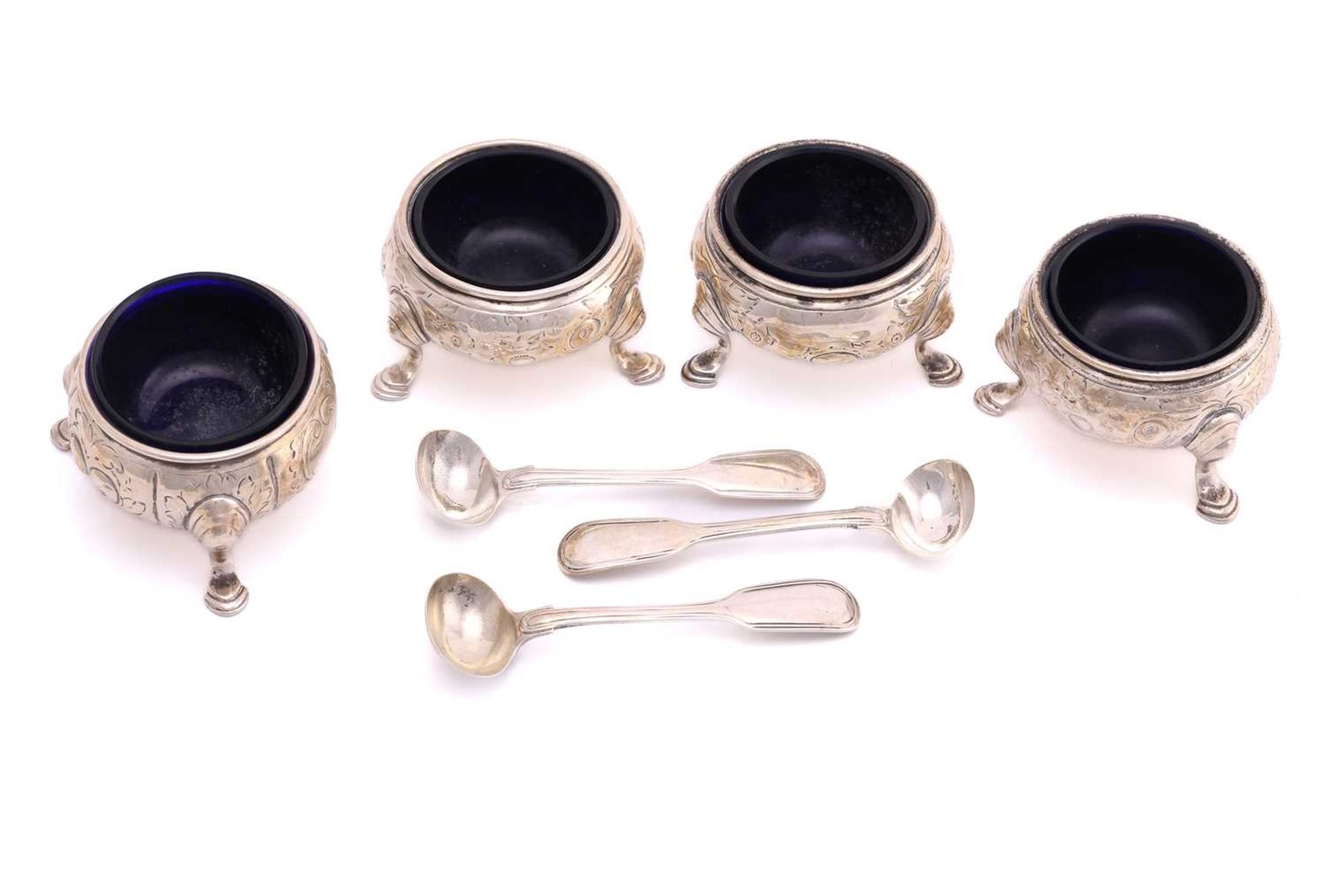 A set of four Victorian silver salt cellars, London 1841 by William Moulson, with blue glass liners,