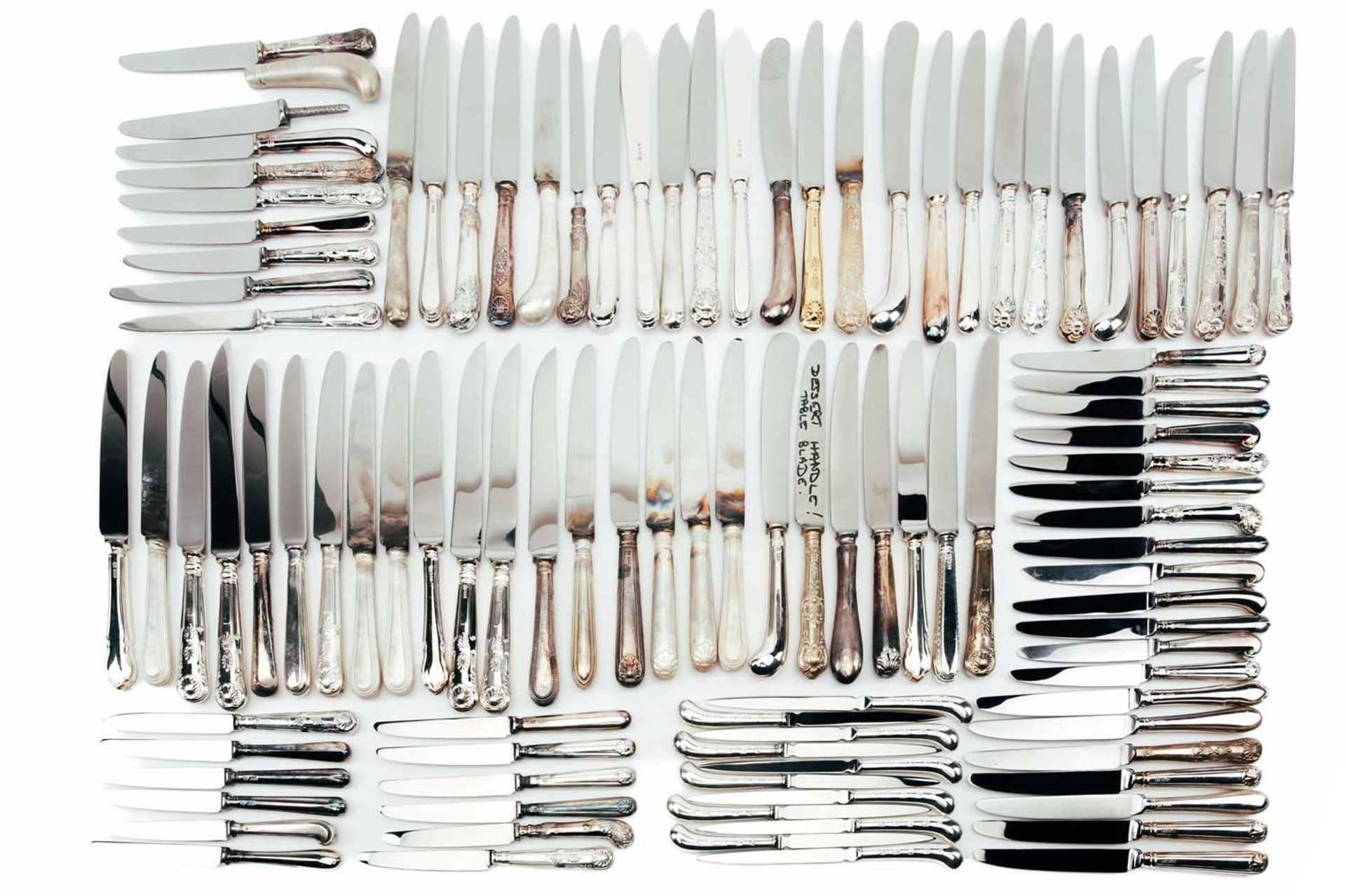 A large mixed collection of various modern silver-handled knives.