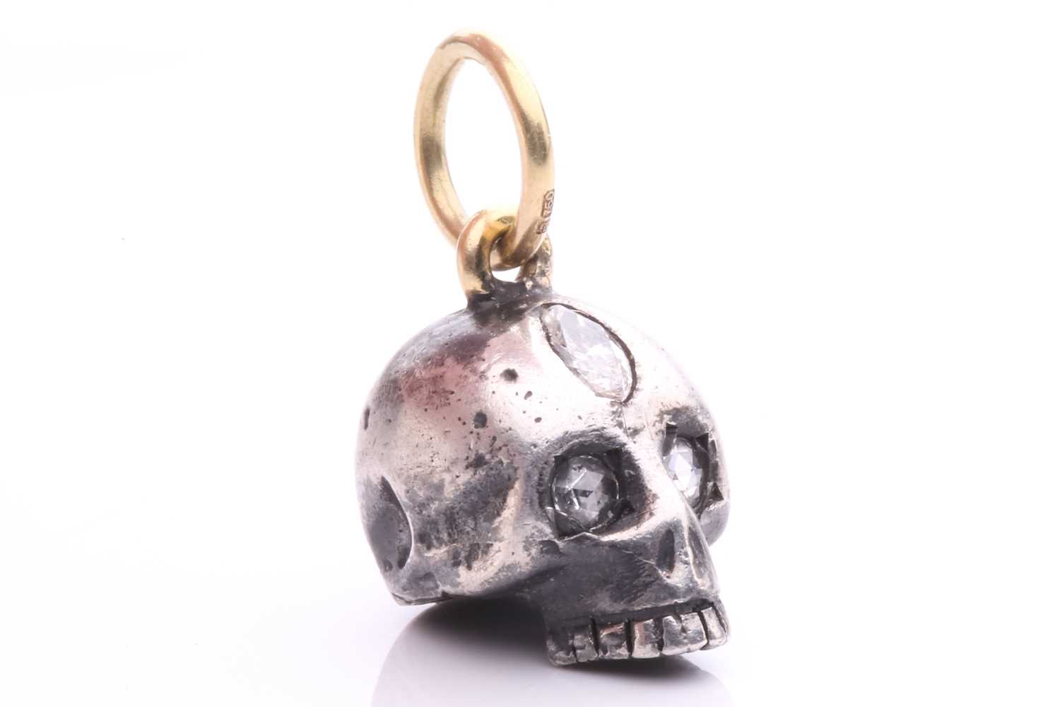 A diamond-set skull charm pendant in silver and 18ct gold, a sculpted hollow skull with eyes set - Image 5 of 6