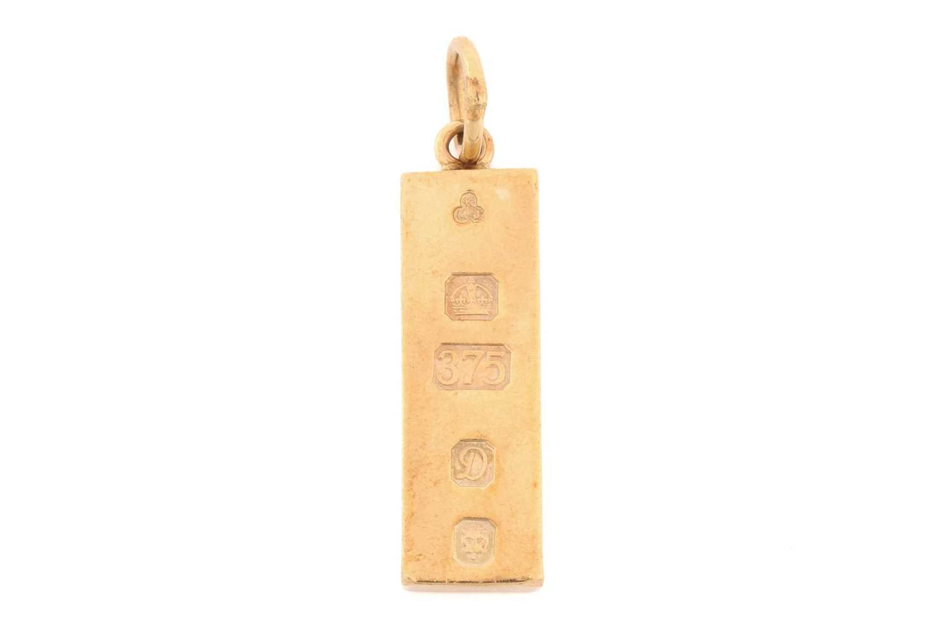 A 9 carat gold ingot pendant; dated 1977. 3.5 cm length; to a jump ring clasp. 20.68 grams