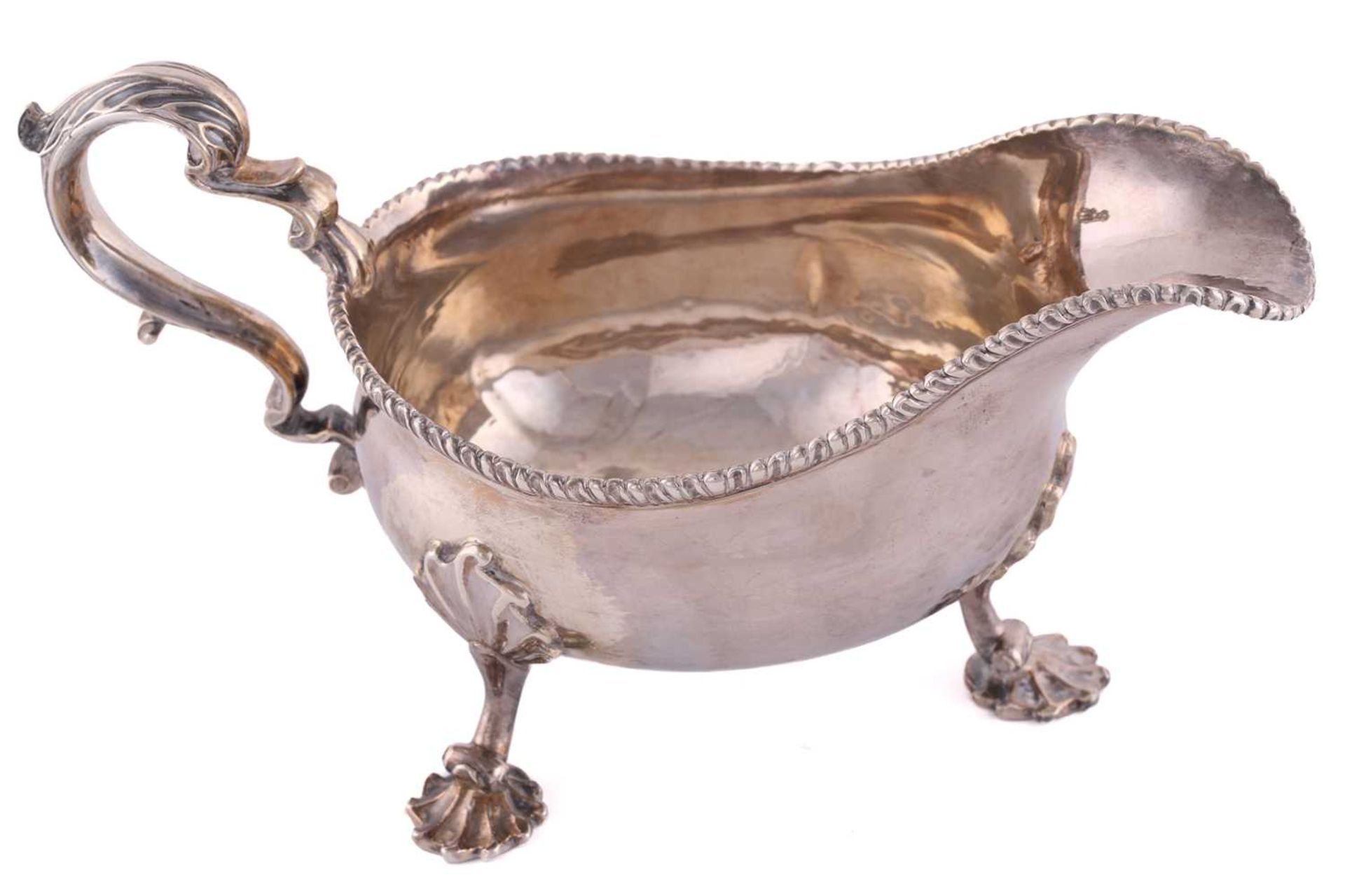 A pair of George II silver sauce boats; with gadrooned borders and leaf capped double scroll - Image 7 of 12