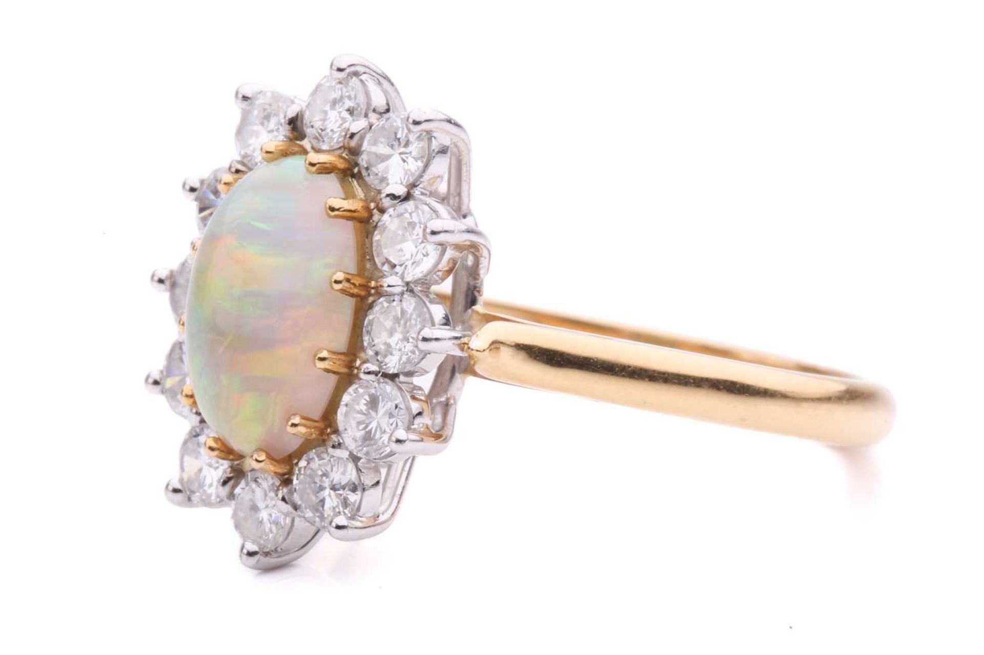 An opal and diamond entourage ring in 18ct gold, featuring an oval precious opal cabochon of 9.2 x - Image 5 of 5