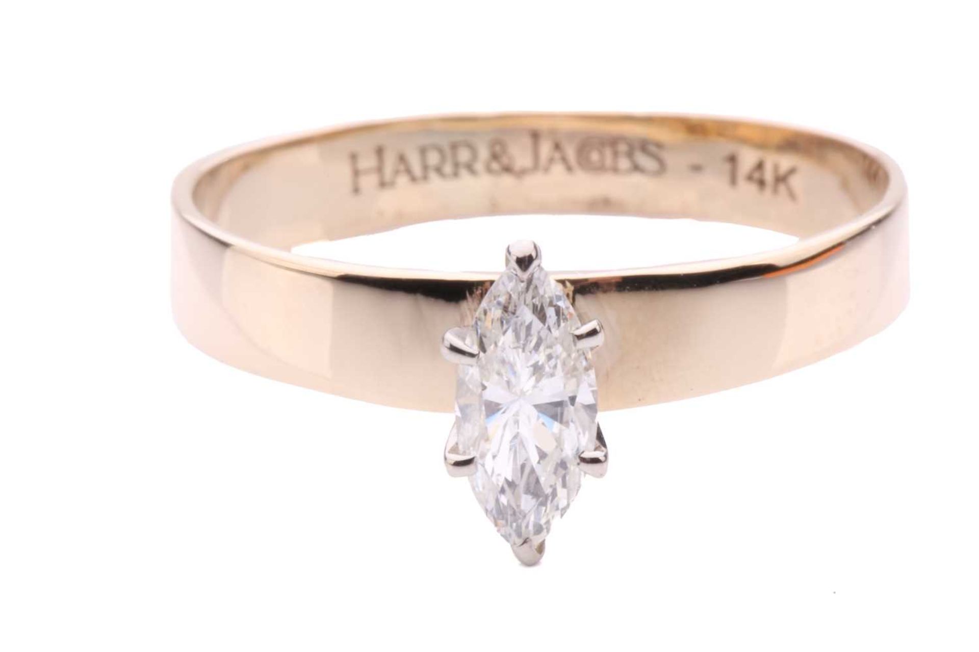 A solitaire diamond ring, the marquise cut diamond approximately 8.5mm by 3.4mm, claw set in