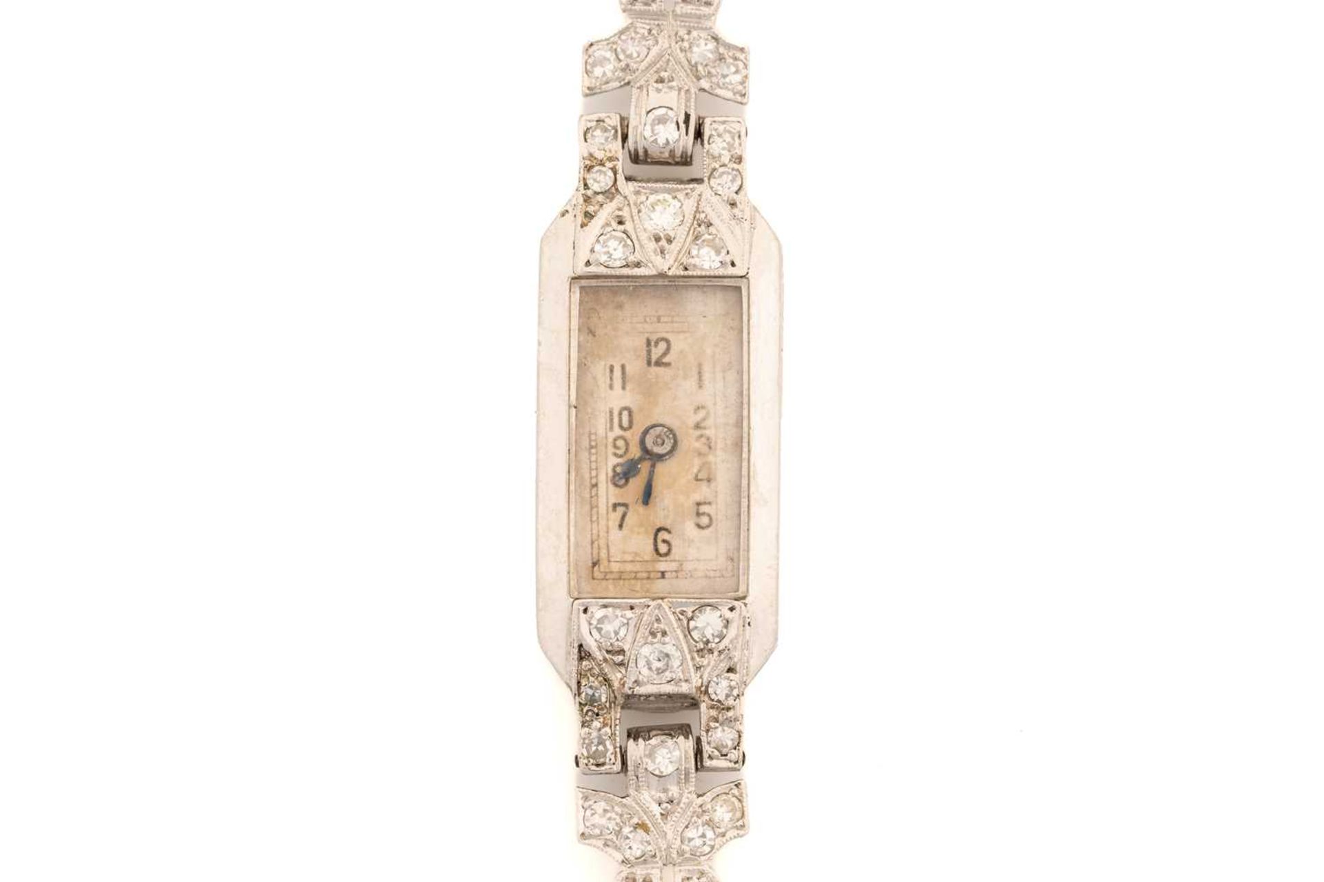 An Art Deco platinum and diamond set cocktail watch, the silvered dial with Arabic numerals, with