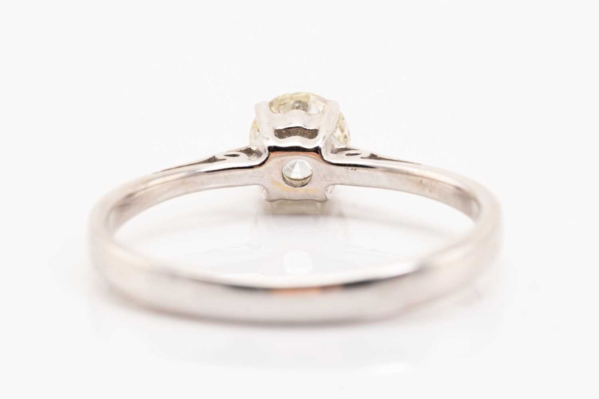 A diamond single stone ring; the round brilliant cut diamond in four claw mount, to a plain polished - Image 4 of 5