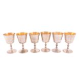 A set of six silver wine goblets, London 1974 by A Haviland-Nye, the tapering bowls with a gilt