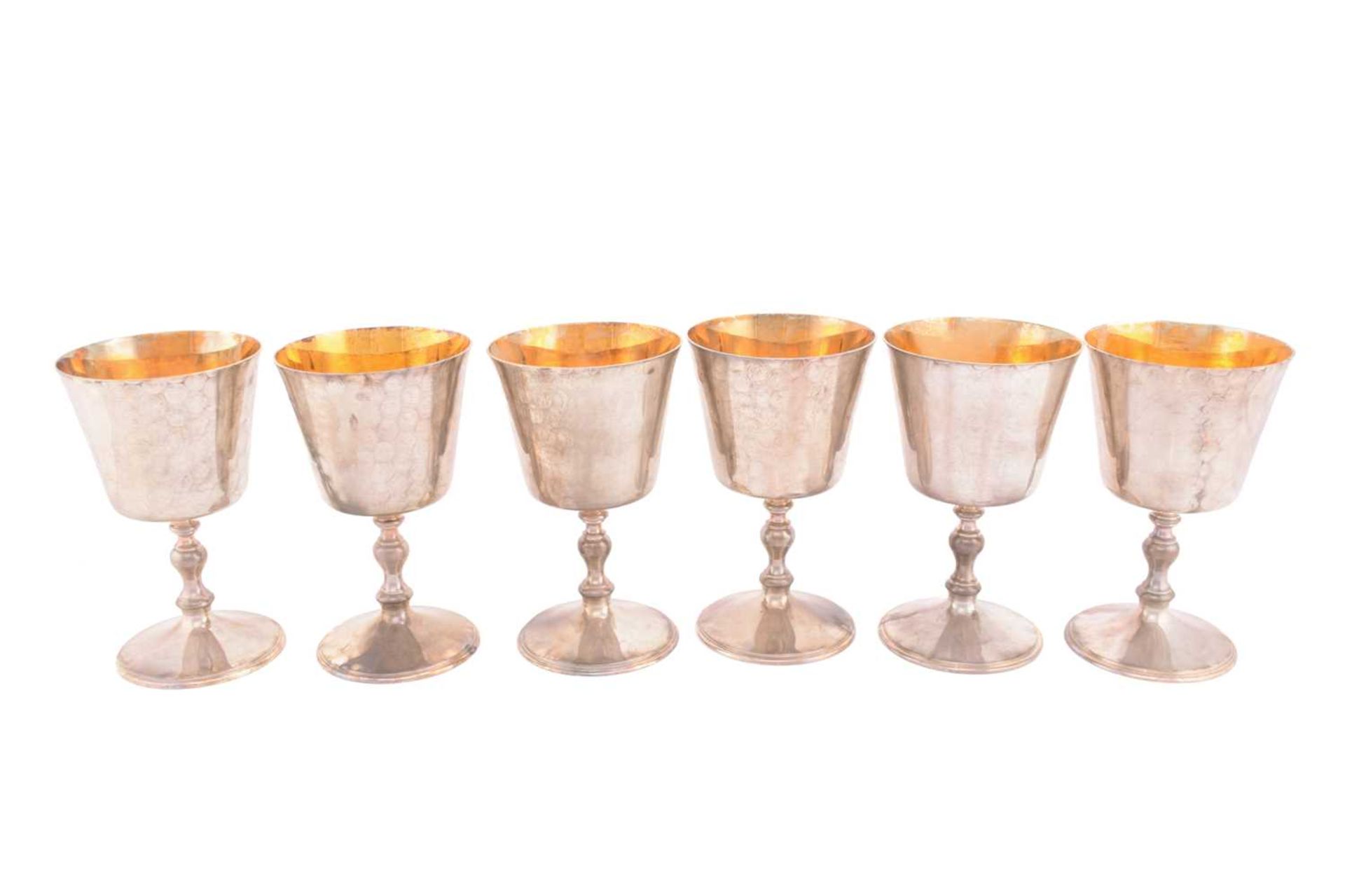 A set of six silver wine goblets, London 1974 by A Haviland-Nye, the tapering bowls with a gilt