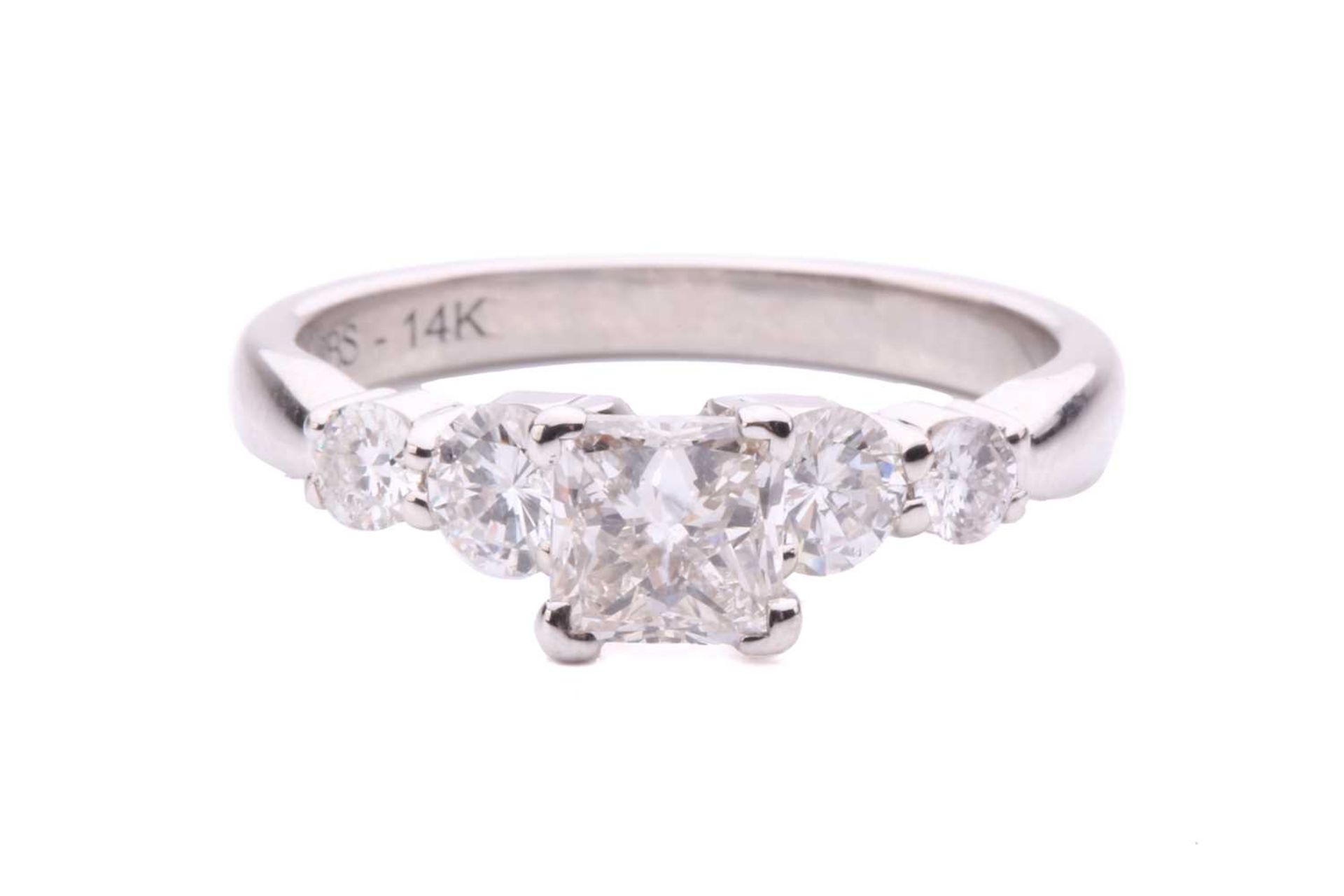 A princess-cut diamond ring with diamond set shoulders, with a central claw set princess-cut diamond