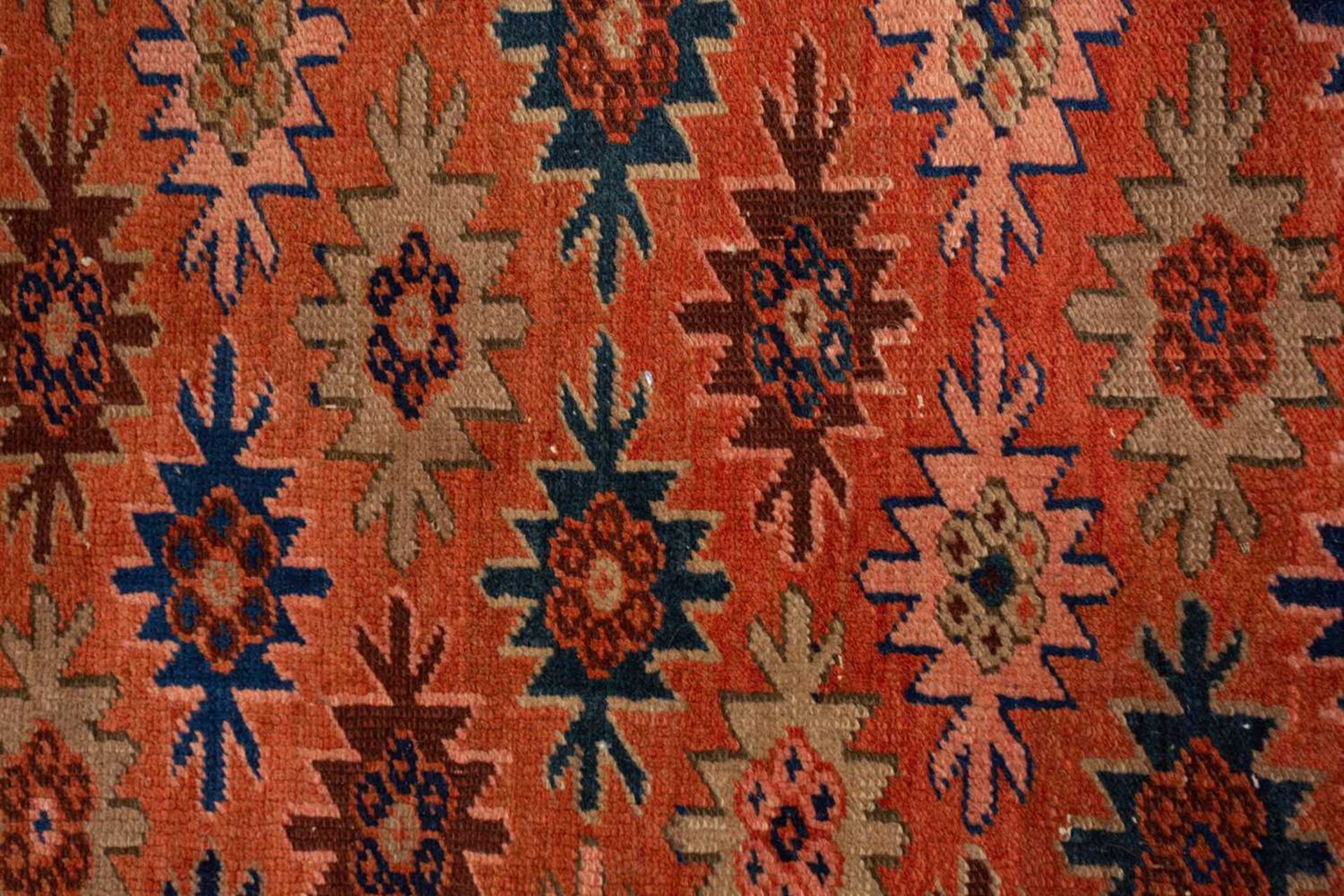 A Caucasian rug with overall star decoration on a muted red ground, probably early 20th-century - Image 2 of 8