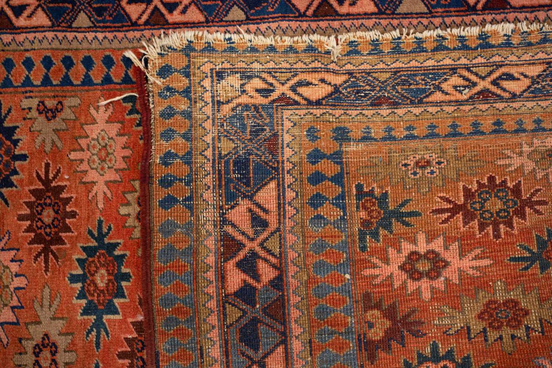 A Caucasian rug with overall star decoration on a muted red ground, probably early 20th-century - Image 8 of 8