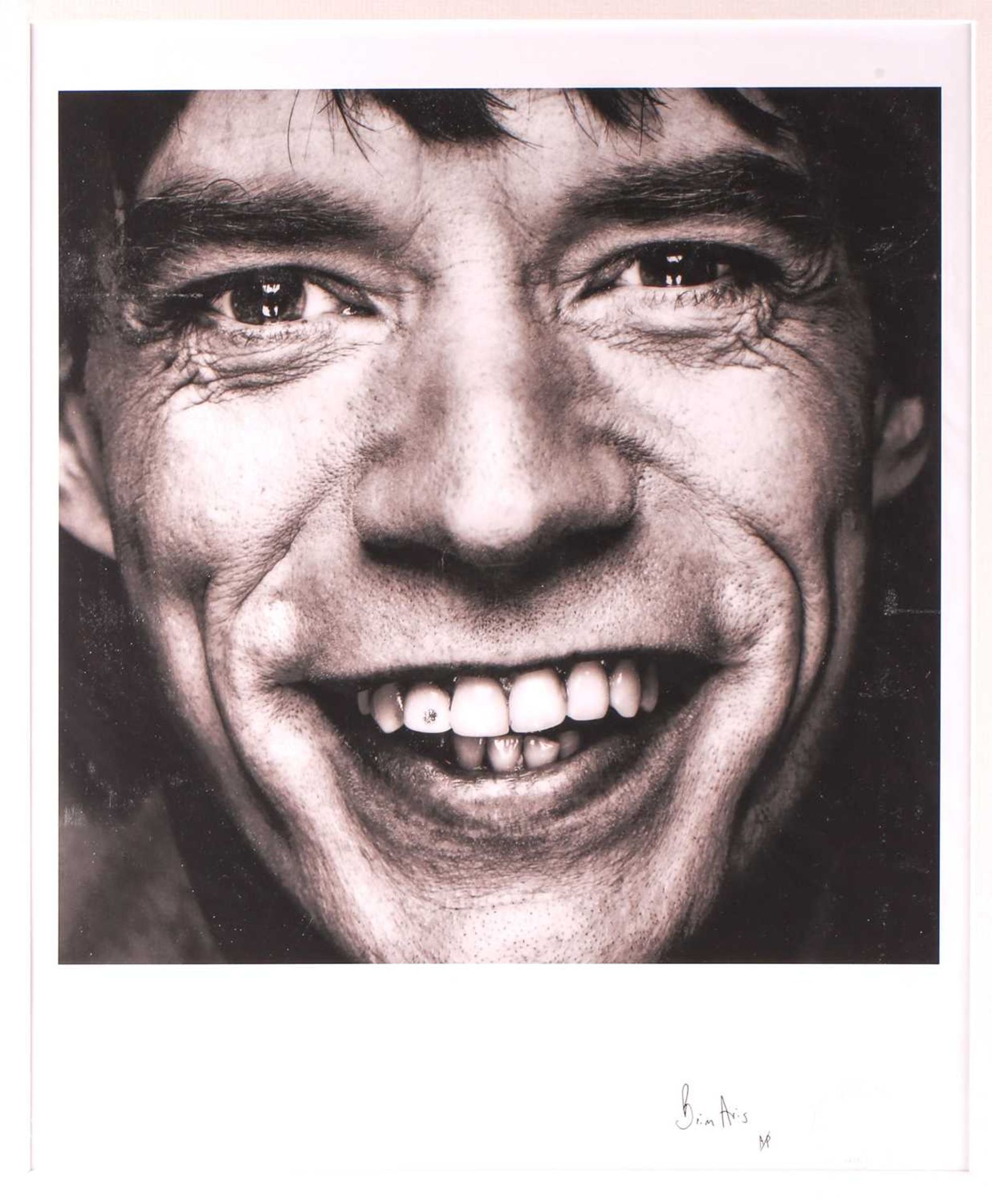 Brian Aris (contemporary), Mick Jagger with diamond tooth, a black and white photographic print,