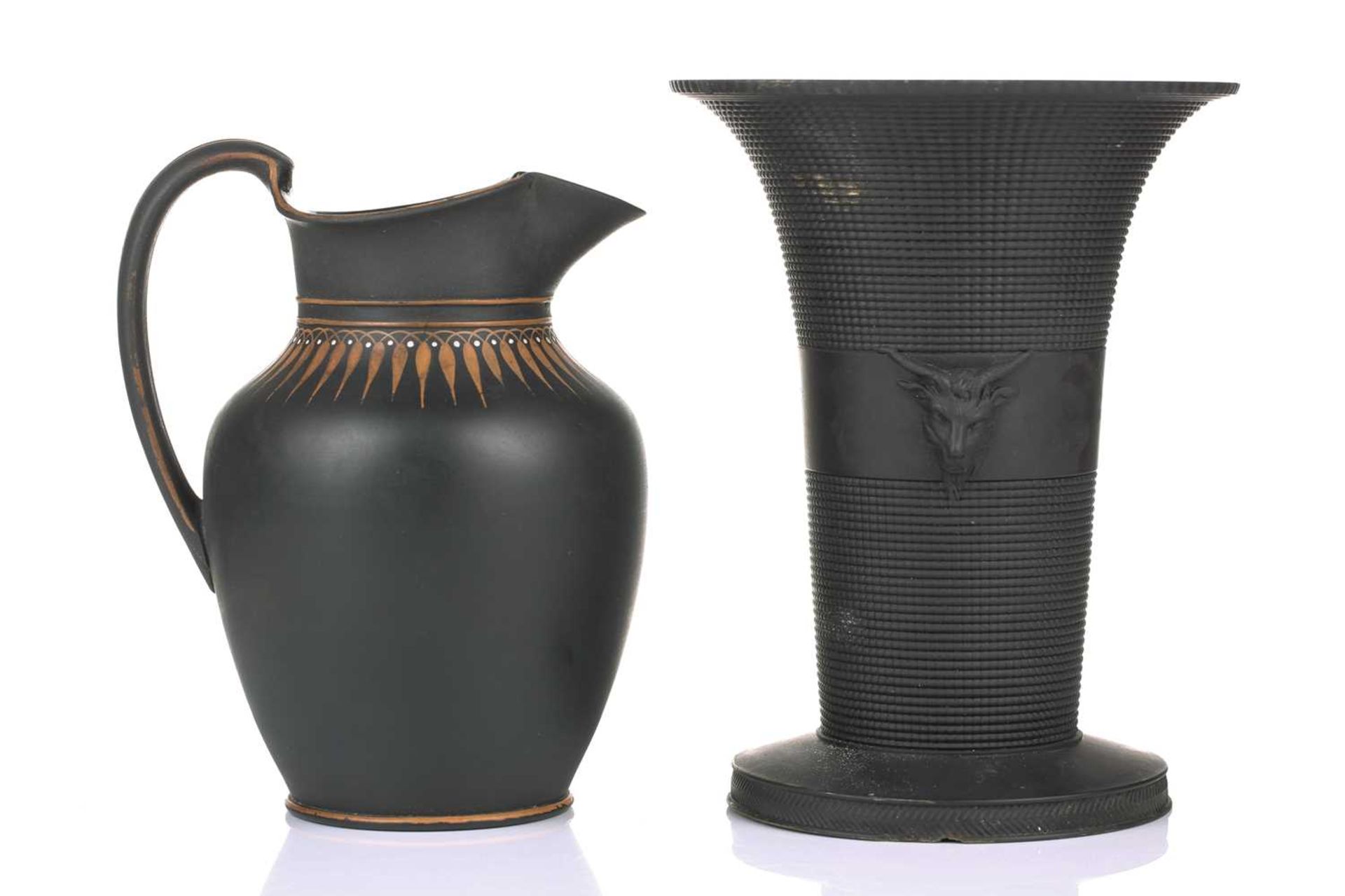 An early 19th century Wedgwood black basalt vase, of flared rim form with twin satyr mask