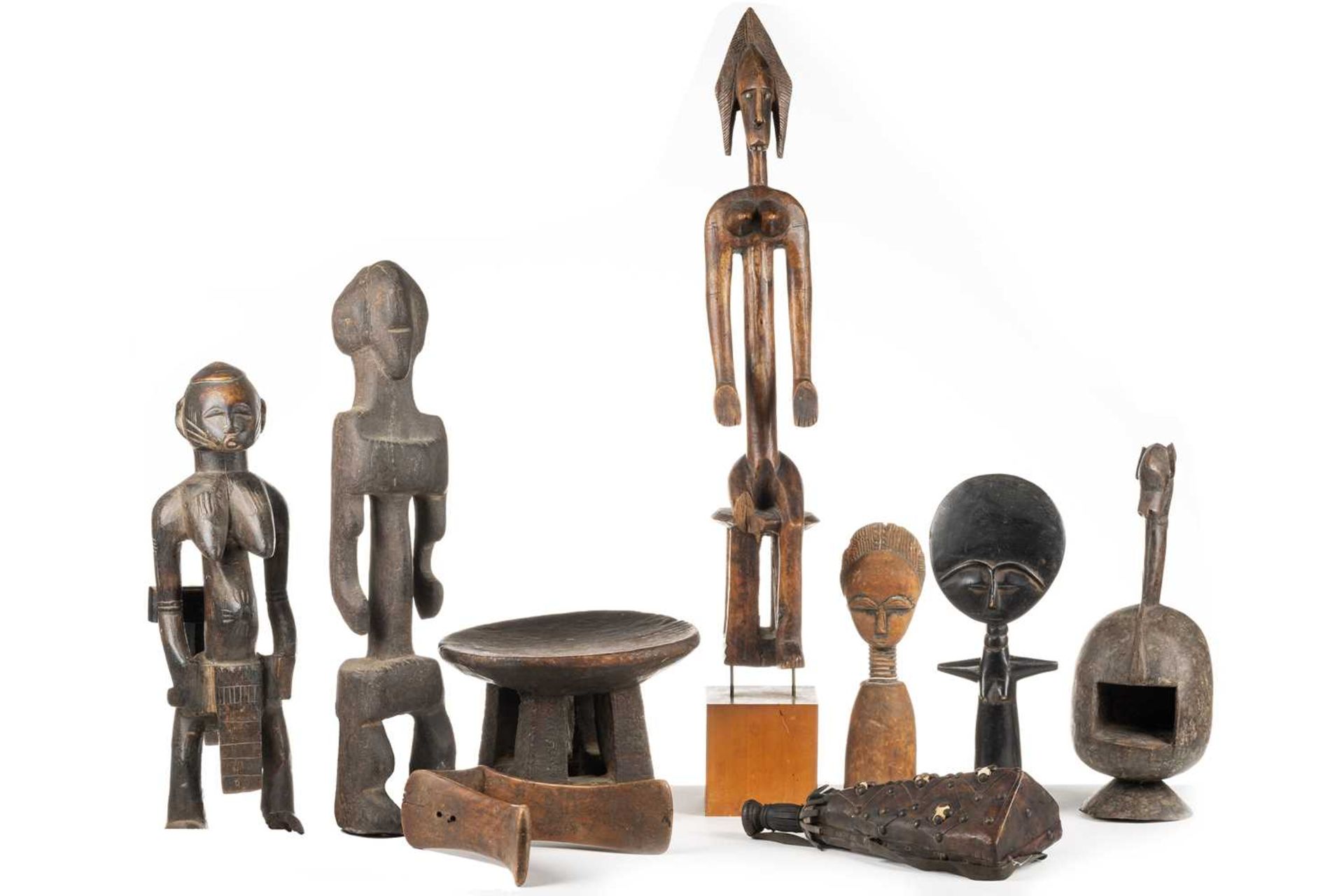 A collection of African ethnographica, comprising a Dogon seated female figure, 60.5cm (excluding