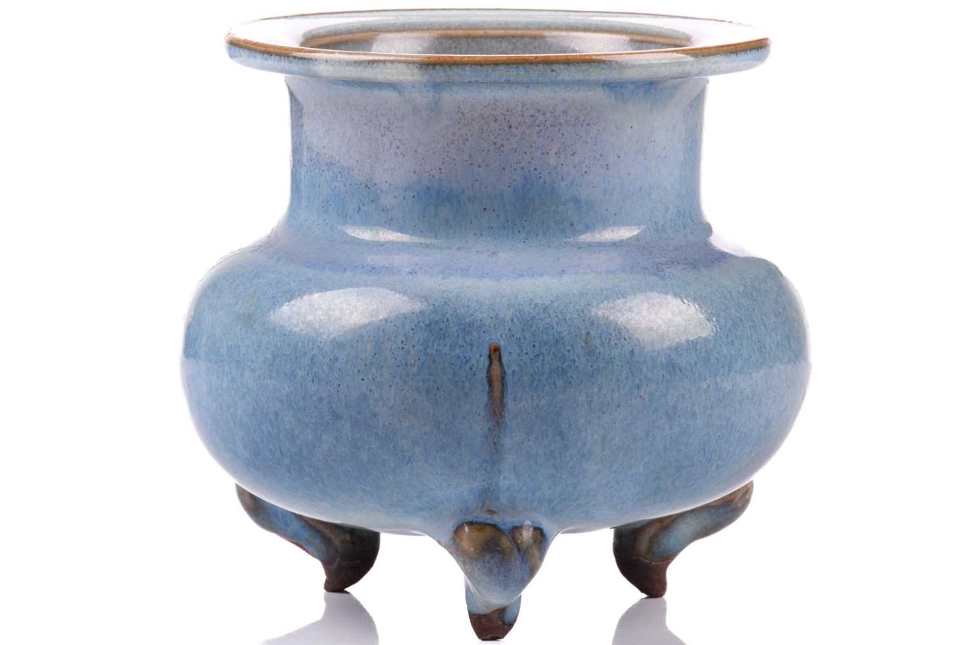 A Chinese Jun style censer, with flattened everted rim above a baluster body, supported on three