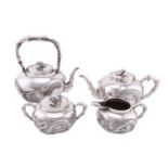 A Chinese silver four piece tea set by Wang Hing, late Qing, the covers with knops in the form of