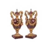 A pair of fine large Napoleon III rouge marble and ormolu serpent-handled urns and covers, each body