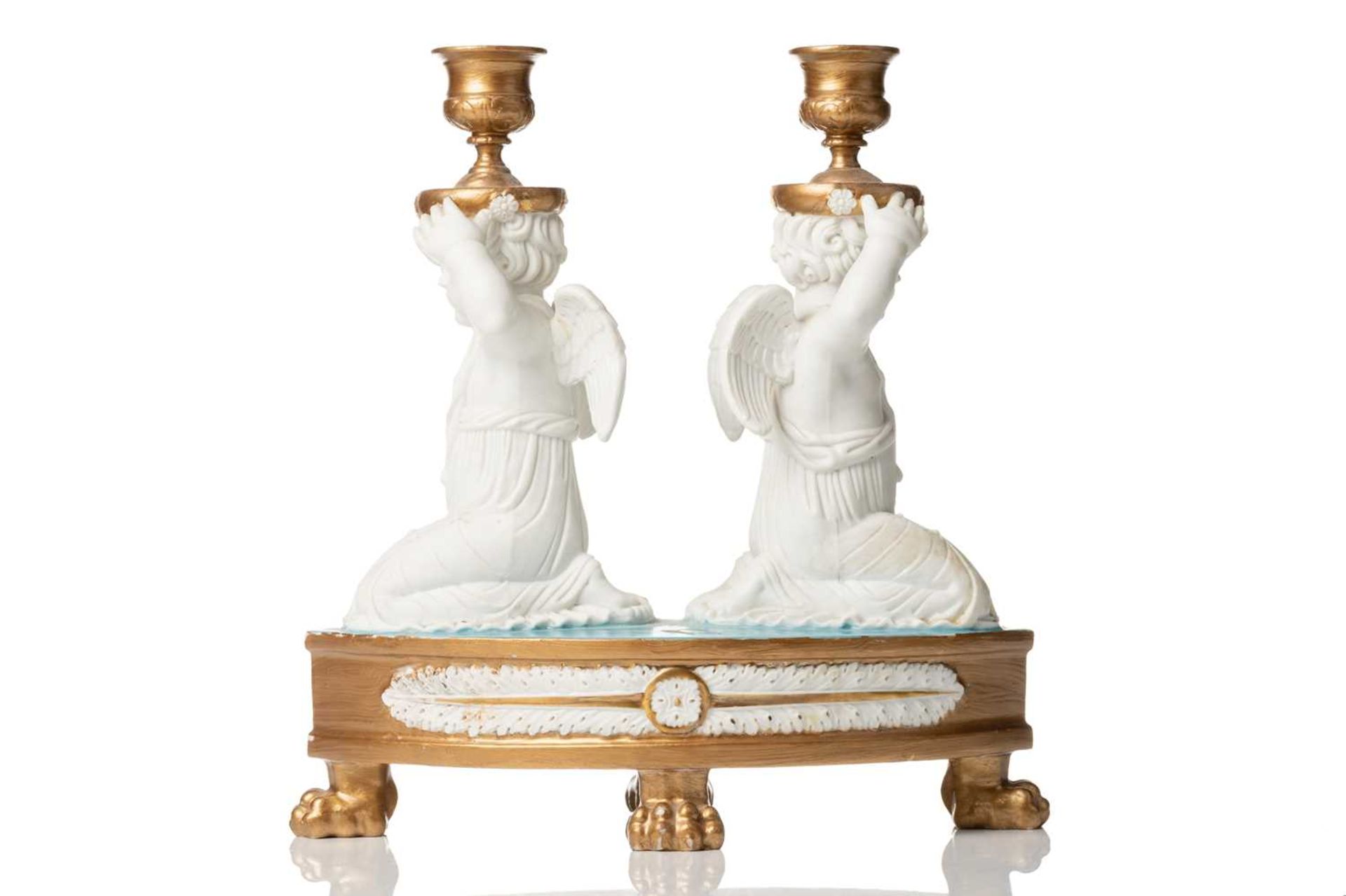 A 19th-century Jacquet et Nedonchelle (Bruxelles) porcelain double candlestick, formed with kneeling