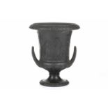 A 19th century Wedgwood black basalt urn of Campagna form, relief decorated with neo-classical