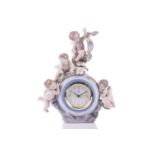 A Lladro porcelain "Angelic Time" (5973) figurative mantle clock. 25 cm wide x 28 cm overall