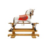 An early 20th century painted and carved wood trestle frame dappled grey rocking horse, with