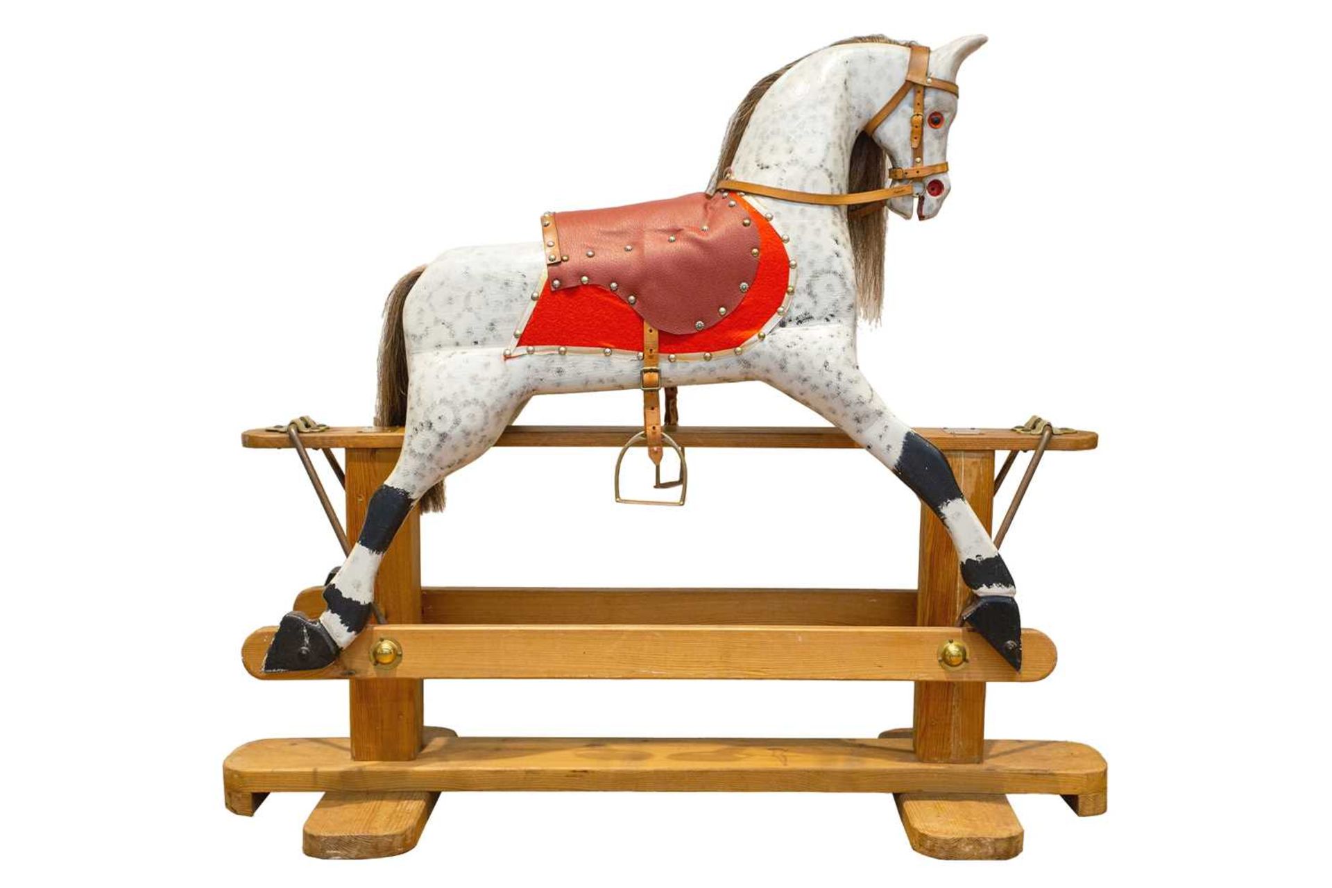 An early 20th century painted and carved wood trestle frame dappled grey rocking horse, with