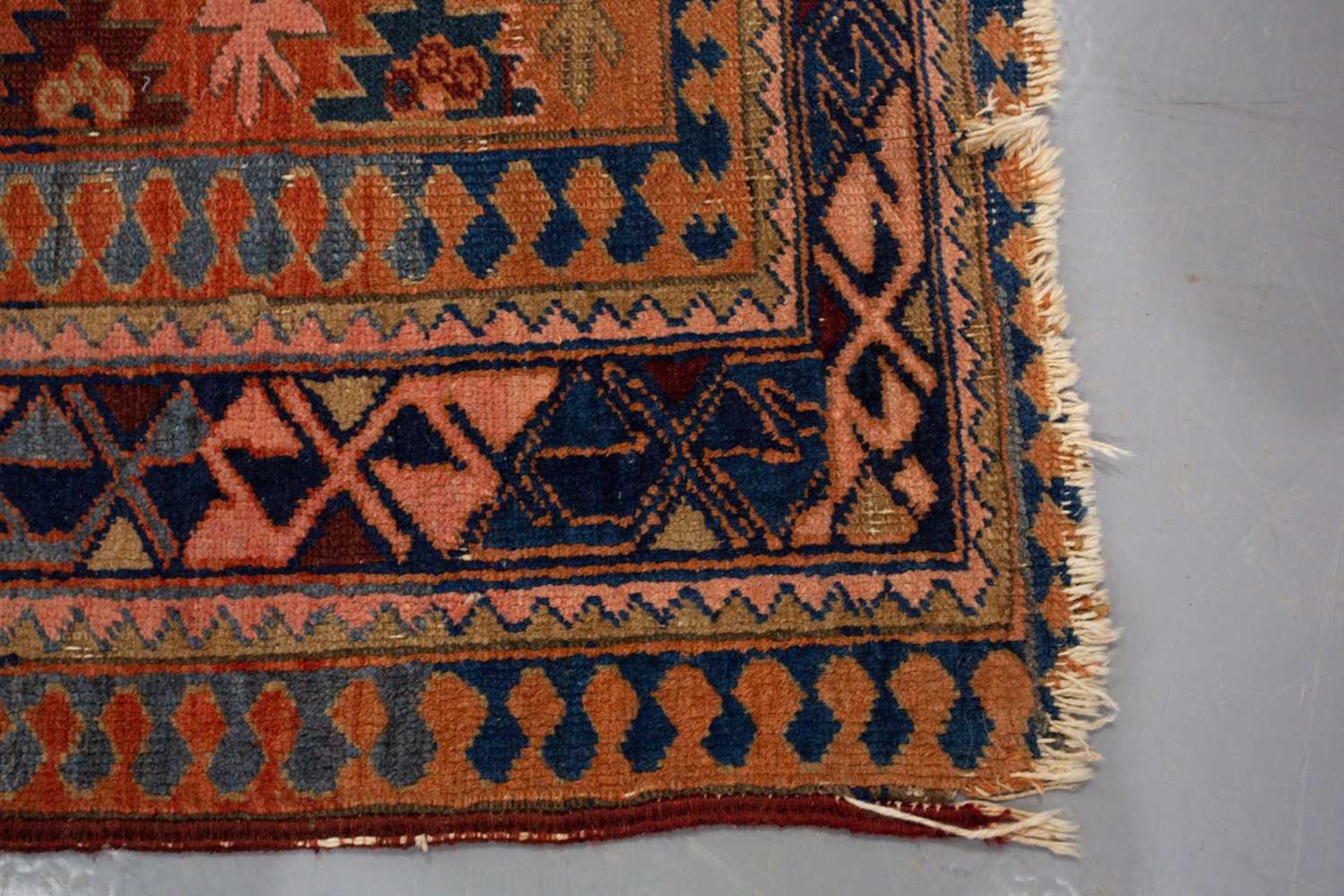 A Caucasian rug with overall star decoration on a muted red ground, probably early 20th-century - Image 4 of 8
