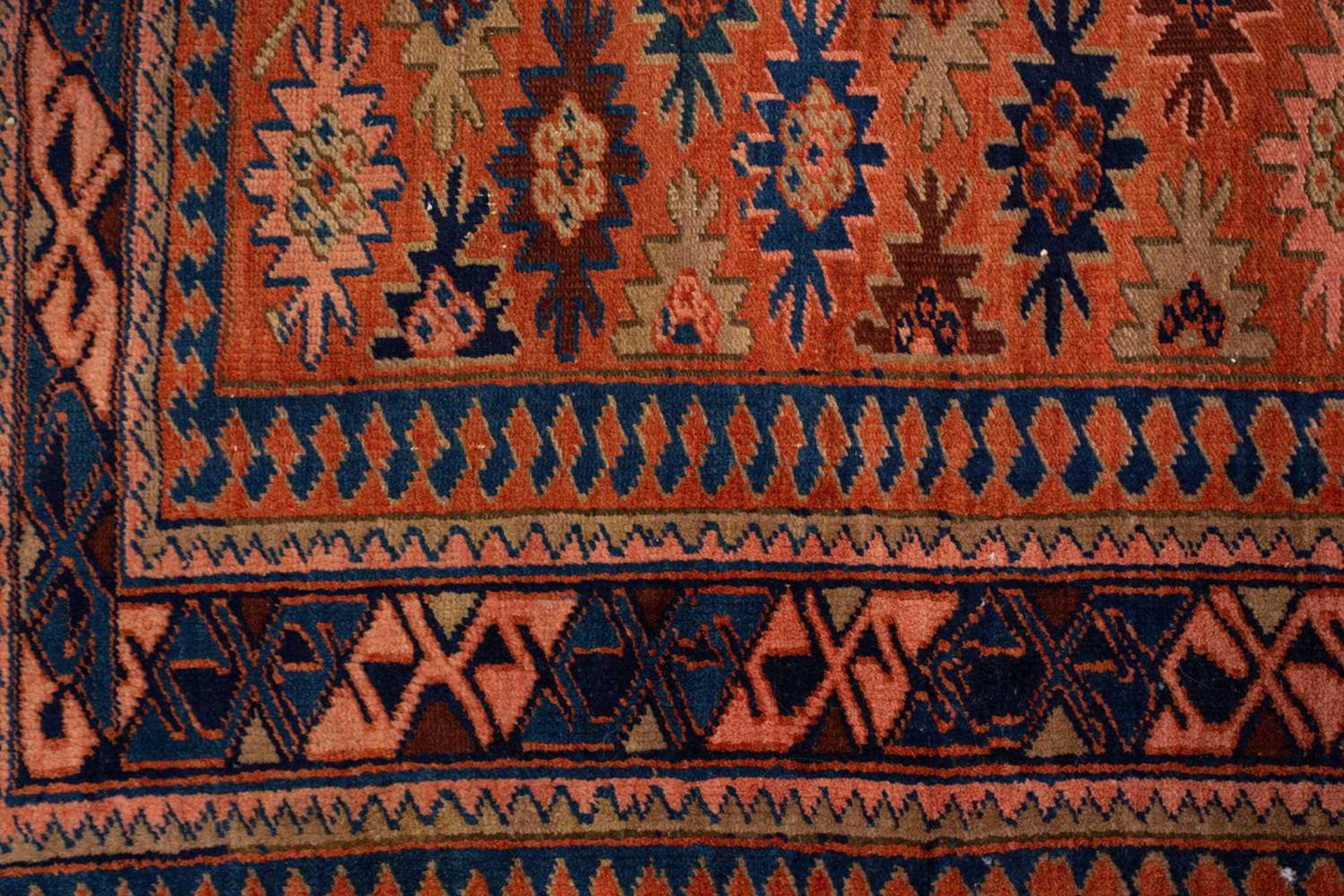 A Caucasian rug with overall star decoration on a muted red ground, probably early 20th-century - Image 3 of 8