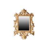 A 19th century Florentine carved giltwood mirror, with bevelled glass in foliate carved frame,