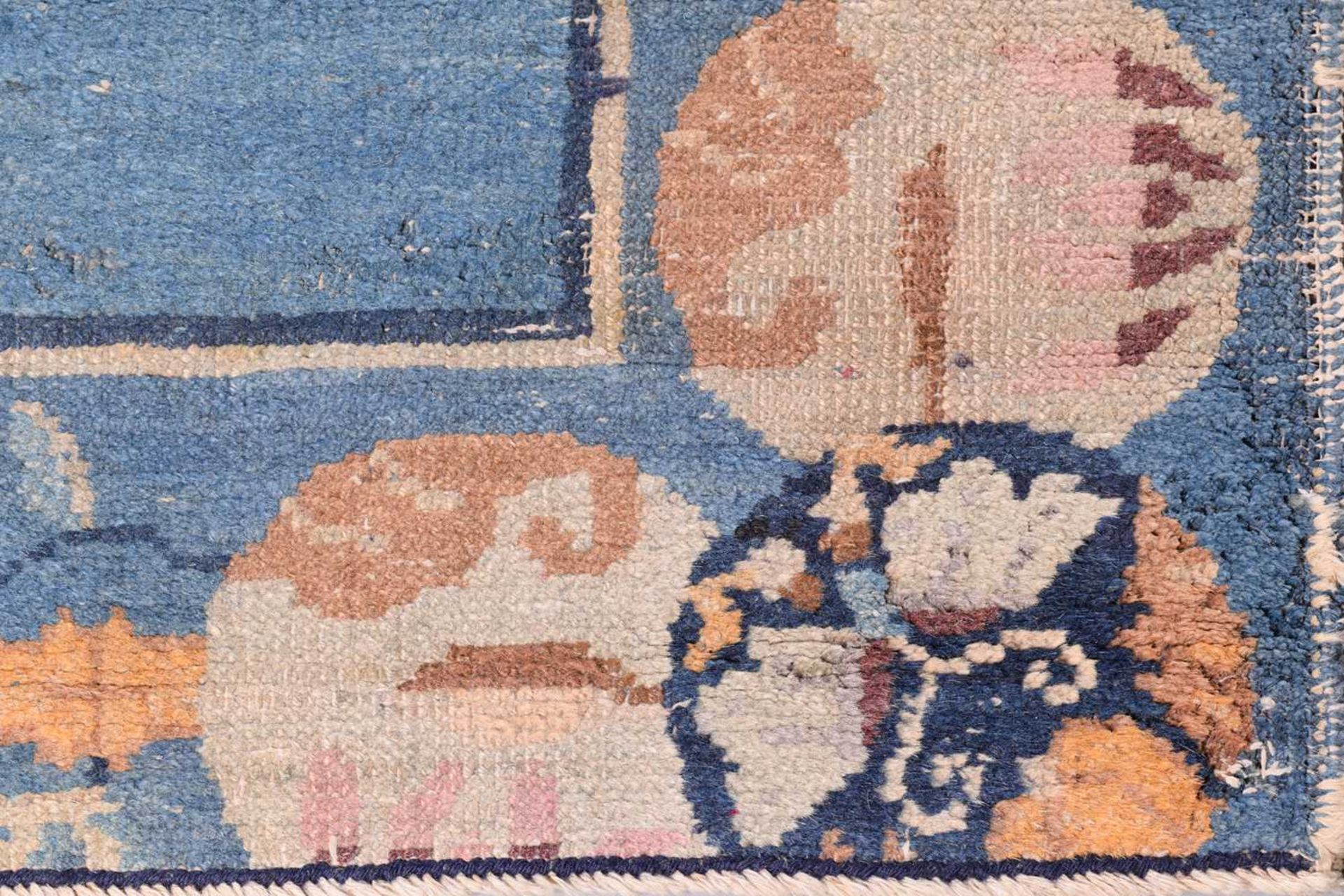 A Chinese Peking blue ground rug, late Qing, within borders of bamboo and butterflies, bearing a - Image 8 of 8