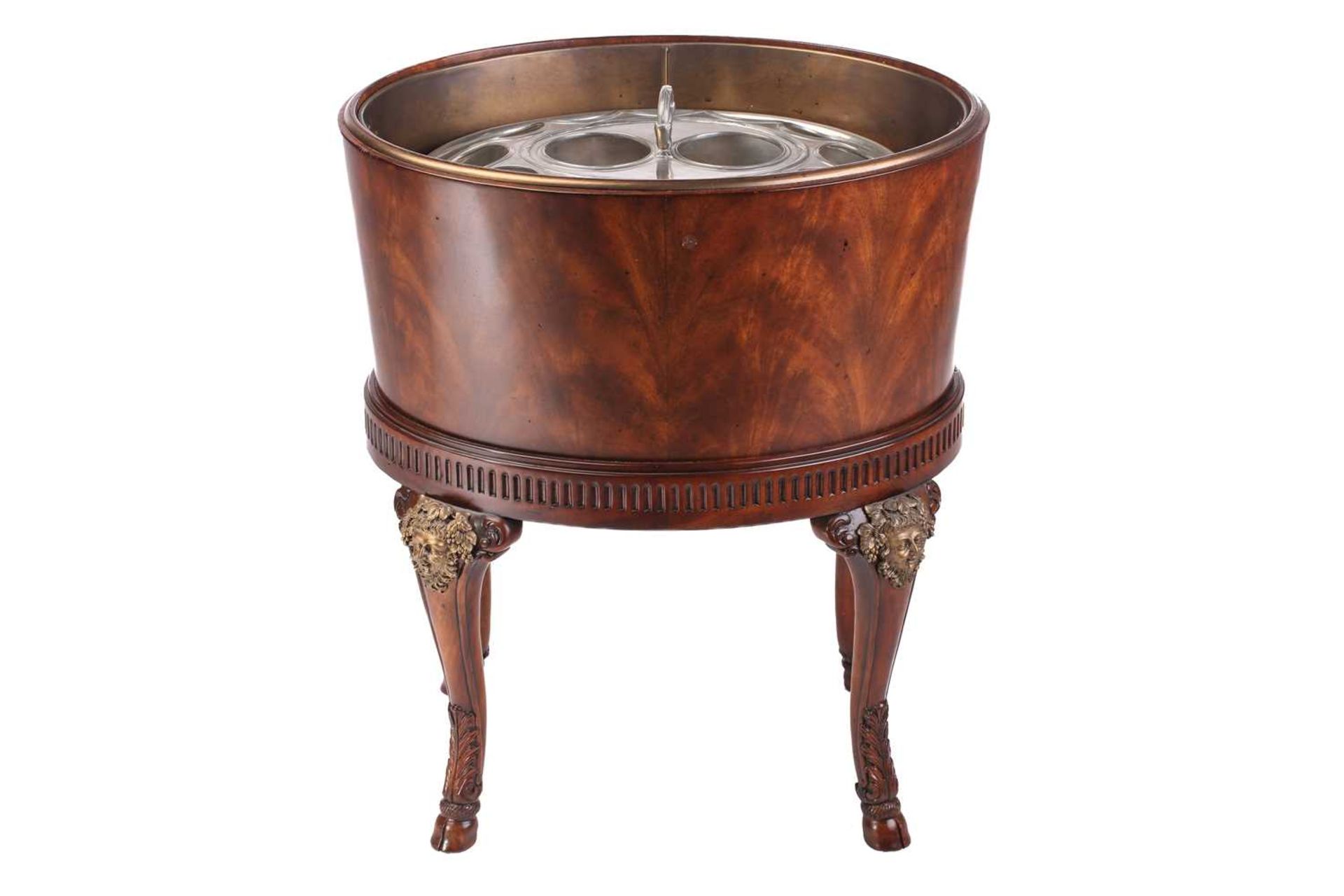 A Theodore Alexander "Rep-Li-Ca" craftsman-made oval mahogany Bachanailian cellarette on stand, 20th