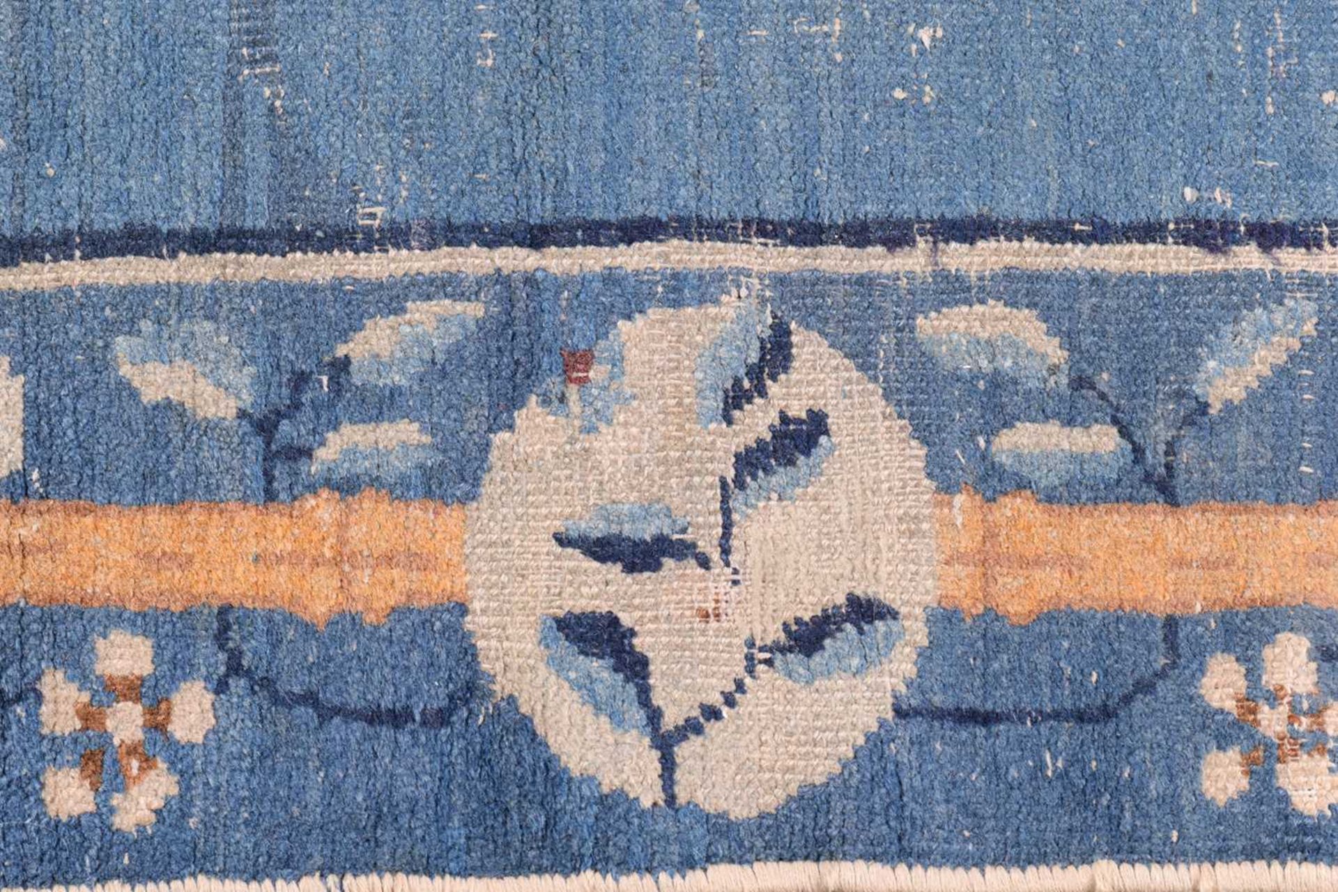 A Chinese Peking blue ground rug, late Qing, within borders of bamboo and butterflies, bearing a - Image 6 of 8