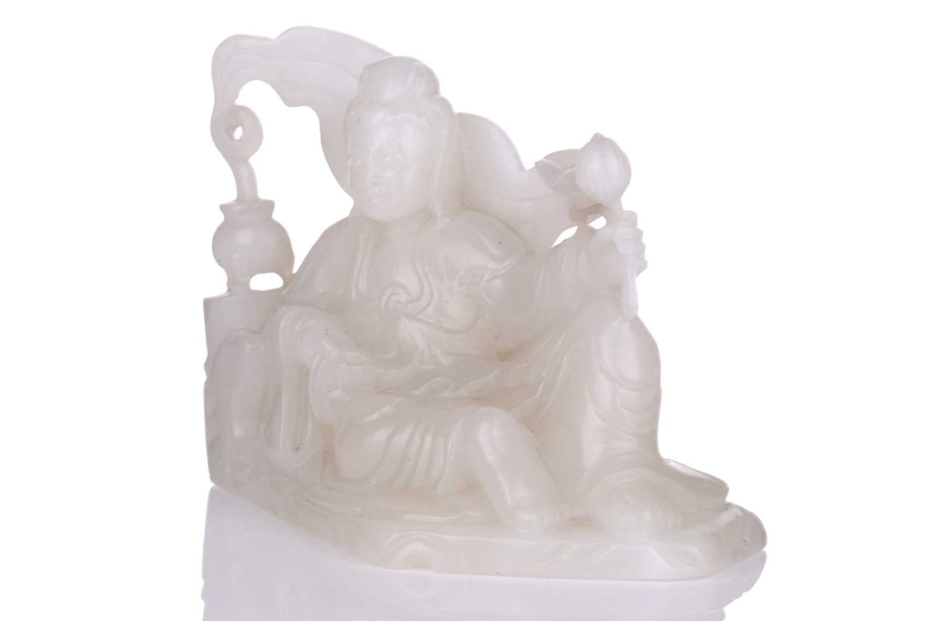 A Chinese white jade figure of Guanyin, seated in a recumbent pose with lotus flower in her left - Image 12 of 14