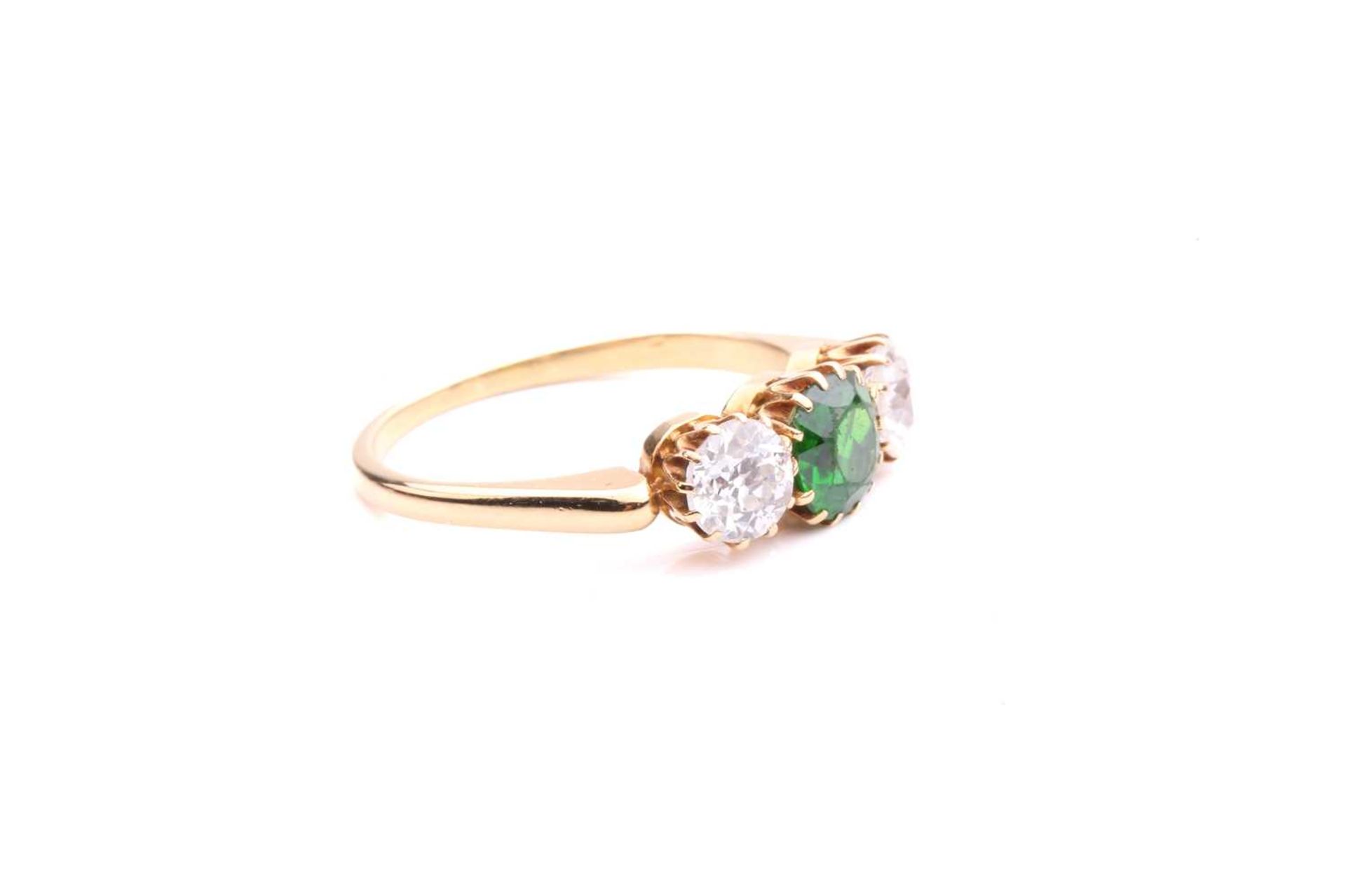 A tsavorite and diamond three-stone ring, centred with a circular-cut tsavorite in intense green - Image 3 of 5