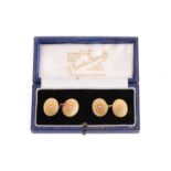 A pair of 18ct gold and seed pearl oval panel cufflinks, connected with cable links, bearing