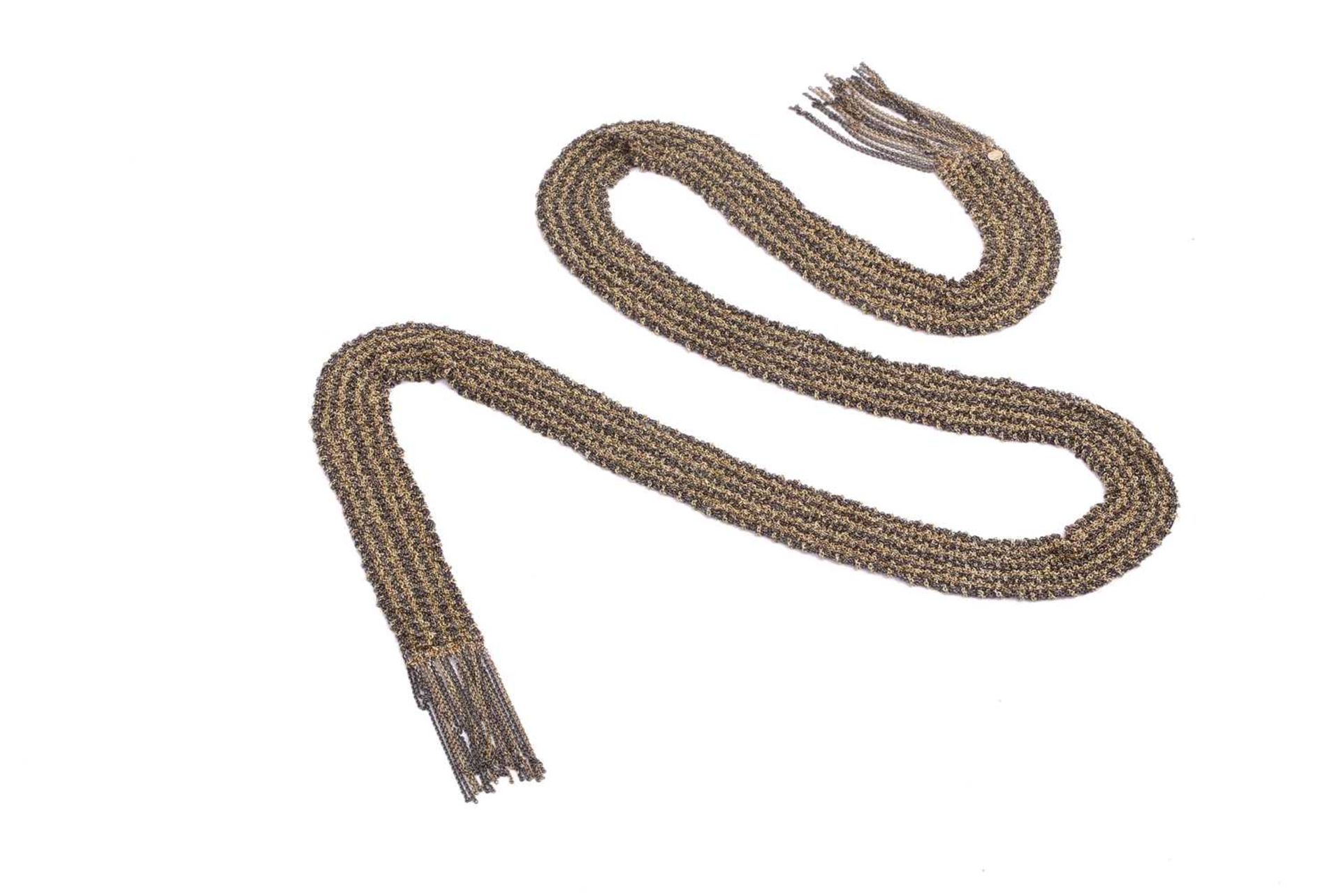 A bi-coloured metal mesh lariat scarf, comprised of alternating lines of fine gilt and oxidised