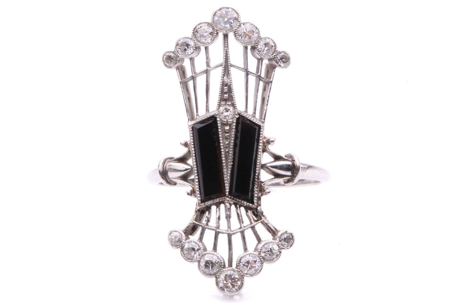 An Edwardian panel ring set with onyx and diamond, the elongated openwork ring head centred with a