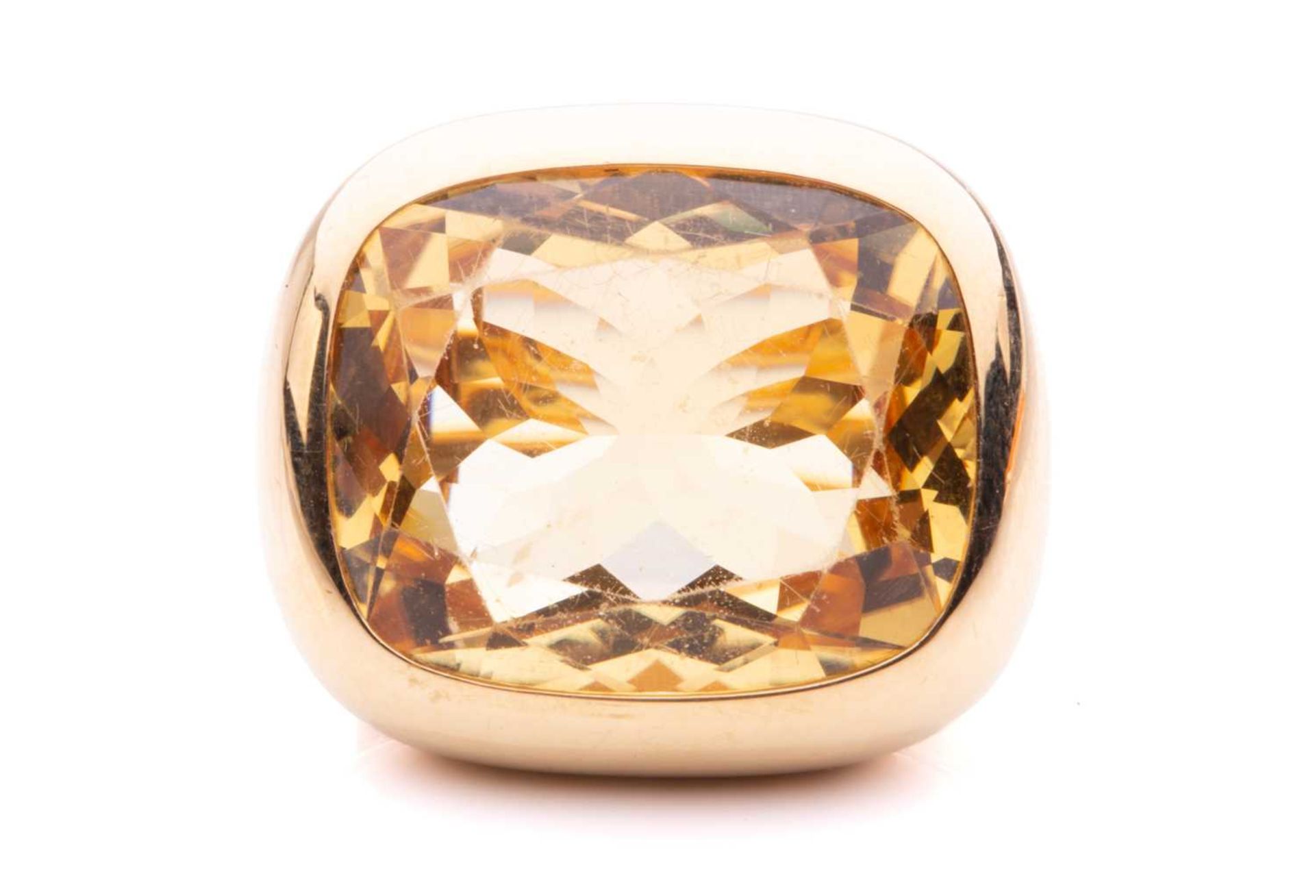 A large citrine cocktail ring, presenting a cushion-shaped light orangey-yellow citrine of 22.2 x